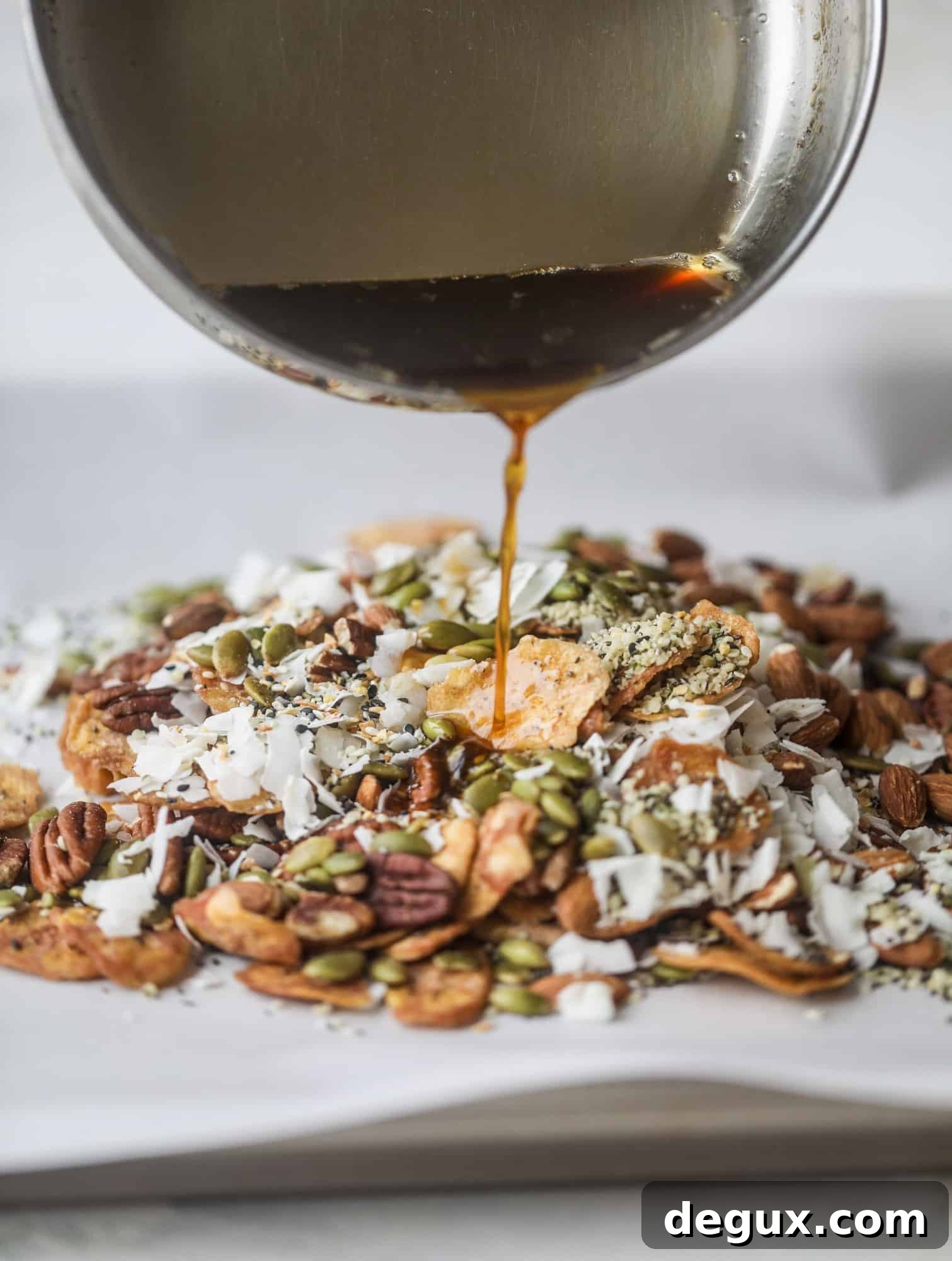 This delicious healthy snack mix is perfect to prep for snacks on the go! It's satisfying, flavorful, both sweet and savory and the best part - is super crunchy. It's full of nuts, some fruit, a bit of coconut, spices, hemp hearts and chia! I howsweeteats.com #healthy #trailmix