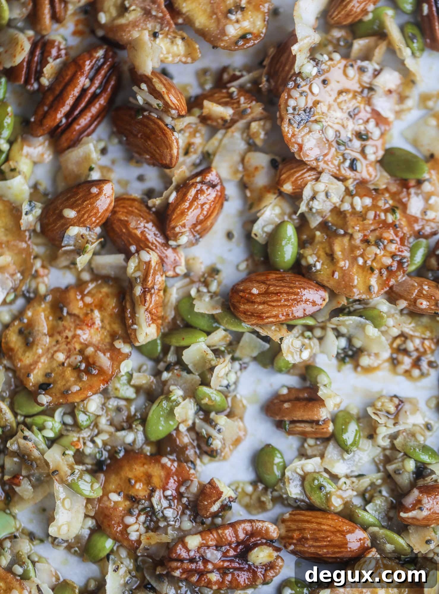 This delicious healthy snack mix is perfect to prep for snacks on the go! It's satisfying, flavorful, both sweet and savory and the best part - is super crunchy. It's full of nuts, some fruit, a bit of coconut, spices, hemp hearts and chia! I howsweeteats.com #healthy #trailmix