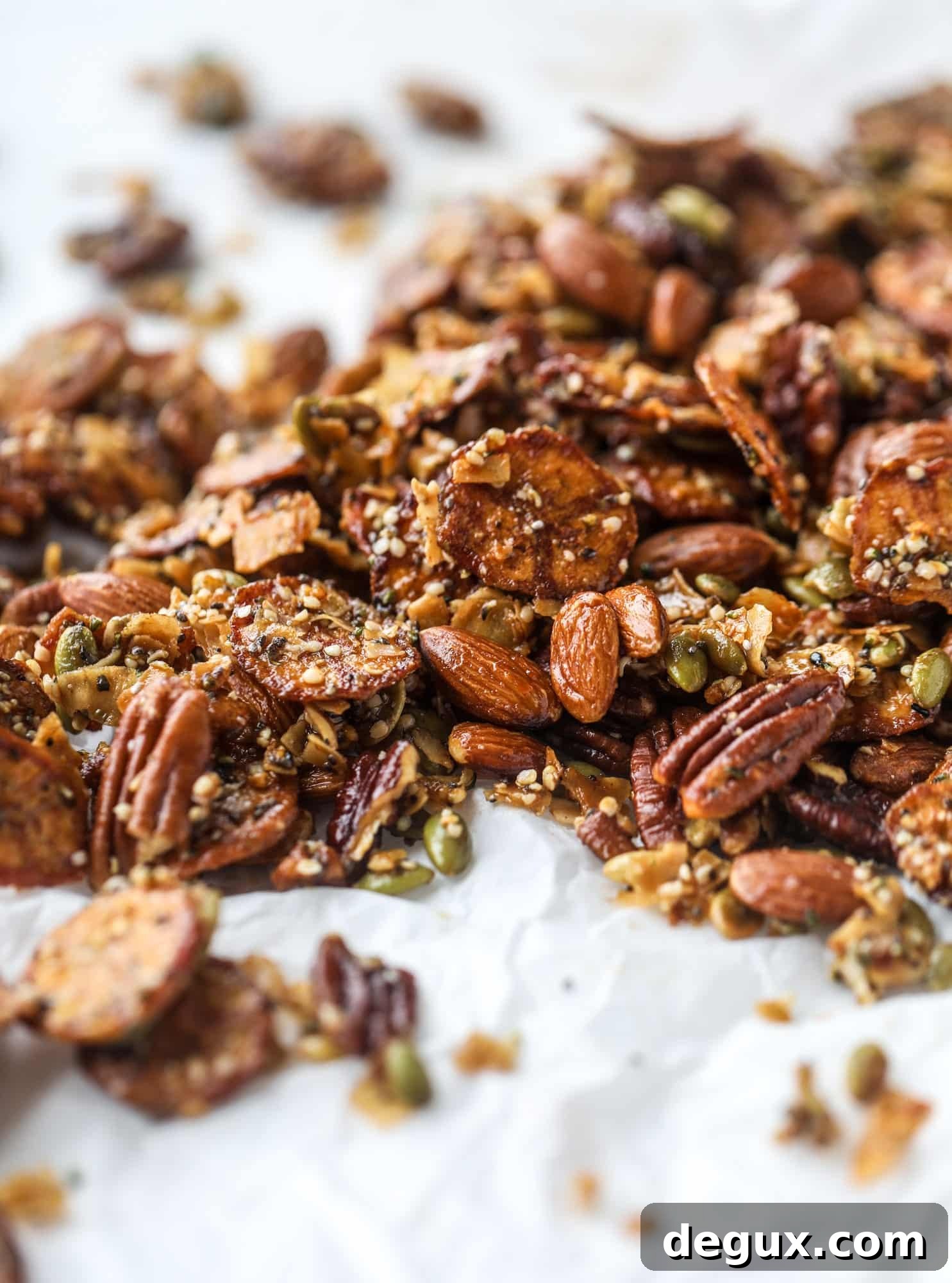 This delicious healthy snack mix is perfect to prep for snacks on the go! It's satisfying, flavorful, both sweet and savory and the best part - is super crunchy. It's full of nuts, some fruit, a bit of coconut, spices, hemp hearts and chia! I howsweeteats.com #healthy #trailmix