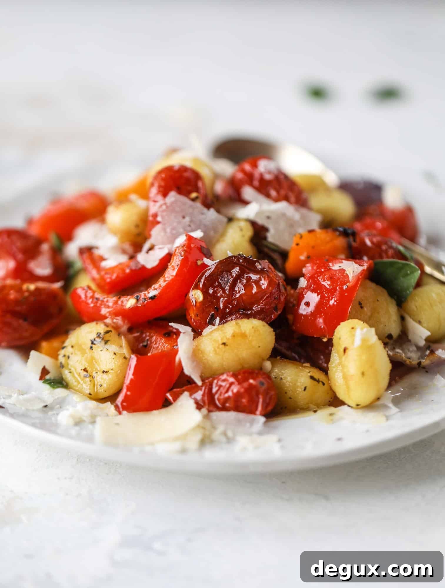 Sheet Pan Gnocchi with Roasted Vegetables and Garlic-Parmesan 8 Sheet pan gnocchi is an easy meal that the whole family will love! Toasted gnocchi along with burst tomatoes and caramelized peppers makes the best dinner. I howsweeteats.com #sheetpan #gnocchi