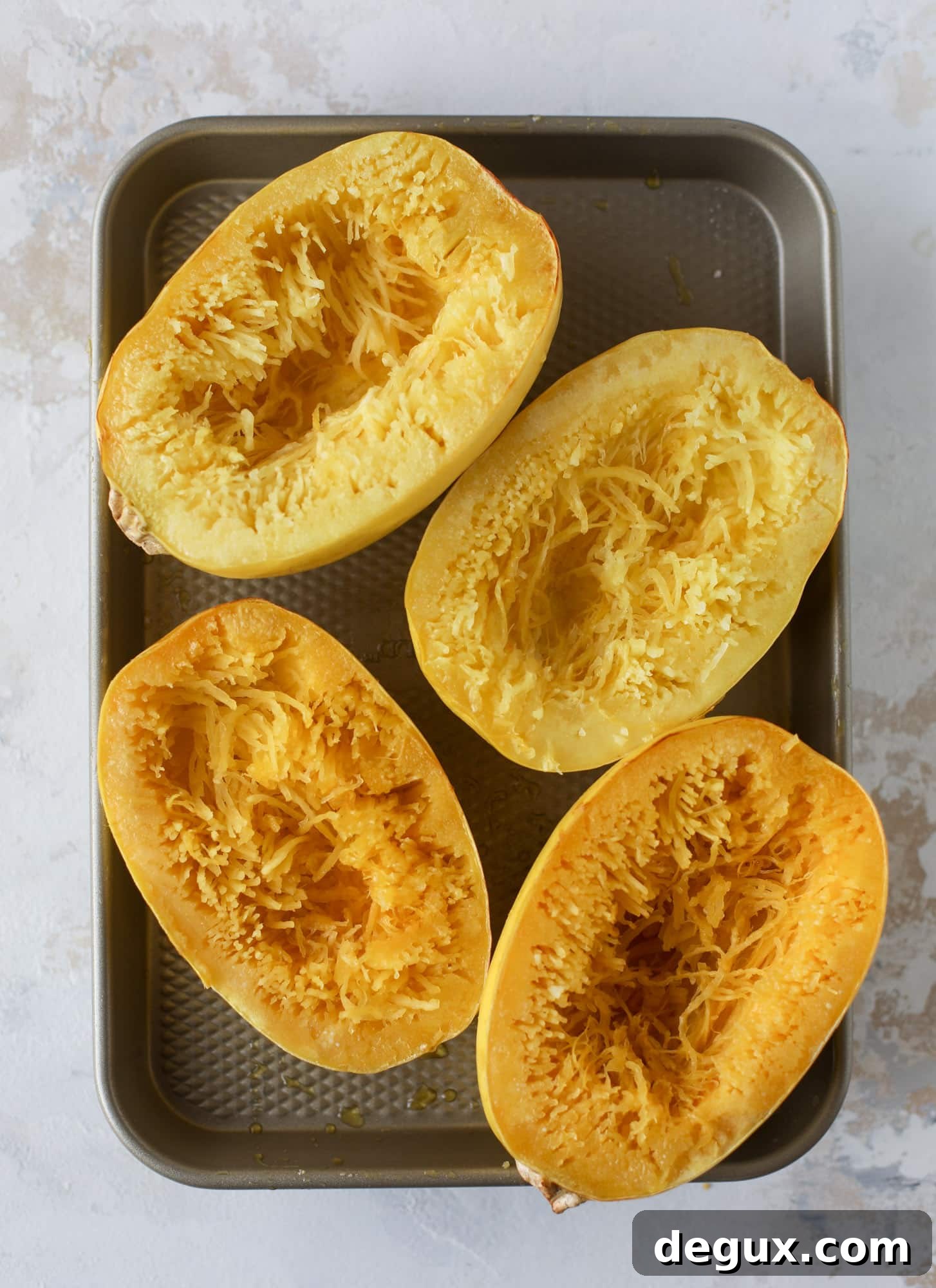 Spaghetti squash parmesan is a delicious weeknight meal! Topped with marinara or bolognese, melty cheese and fresh herbs, it's easy and delicious! I howsweeteats.com #spaghettisquash #parmesan