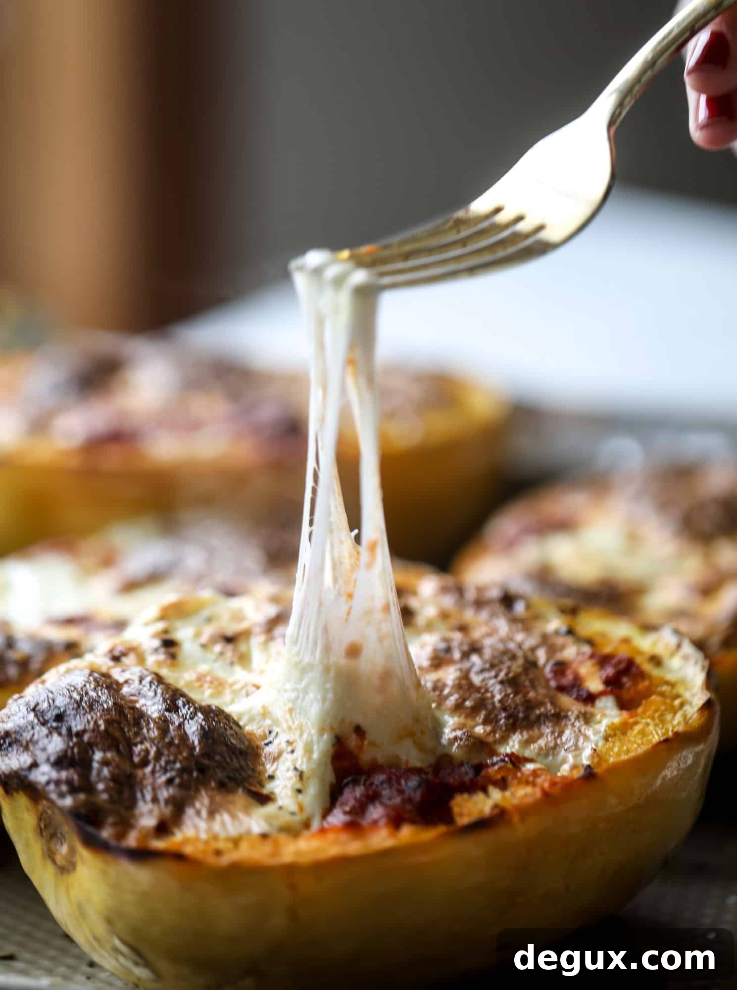 Spaghetti squash parmesan is a delicious weeknight meal! Topped with marinara or bolognese, melty cheese and fresh herbs, it's easy and delicious! I howsweeteats.com #spaghettisquash #parmesan