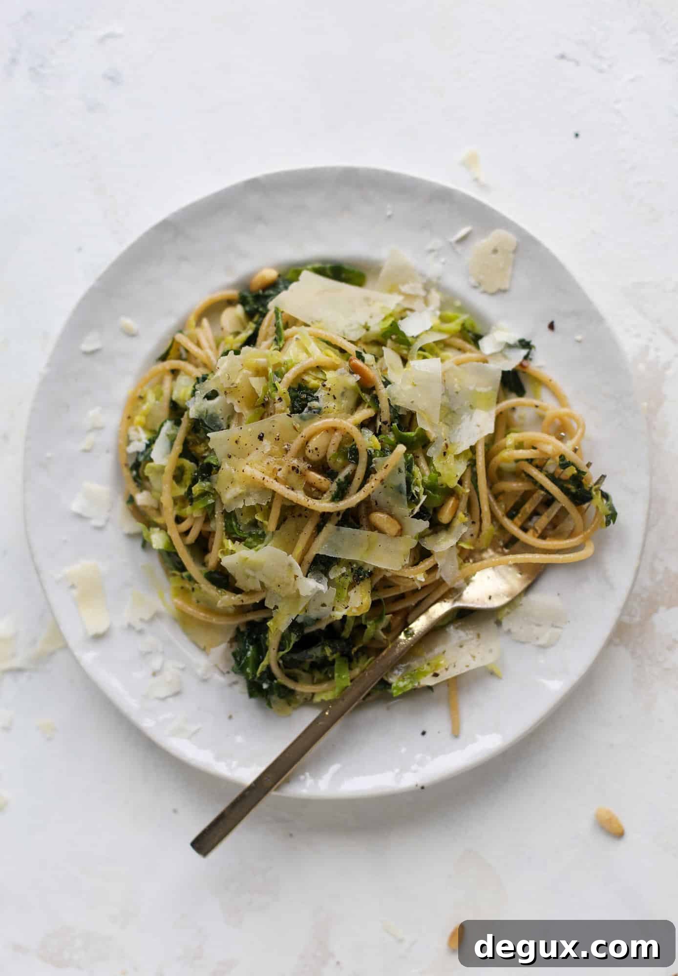 Brussels Sprouts and Kale Spaghetti with Parmesan & Pine Nuts 2 This brussels spaghetti with kale, parmesan and pine nuts is a super flavorful, quick and easy weeknight meal. You can add in a protein if you wish! I howsweeteats.com #brussels #spaghetti