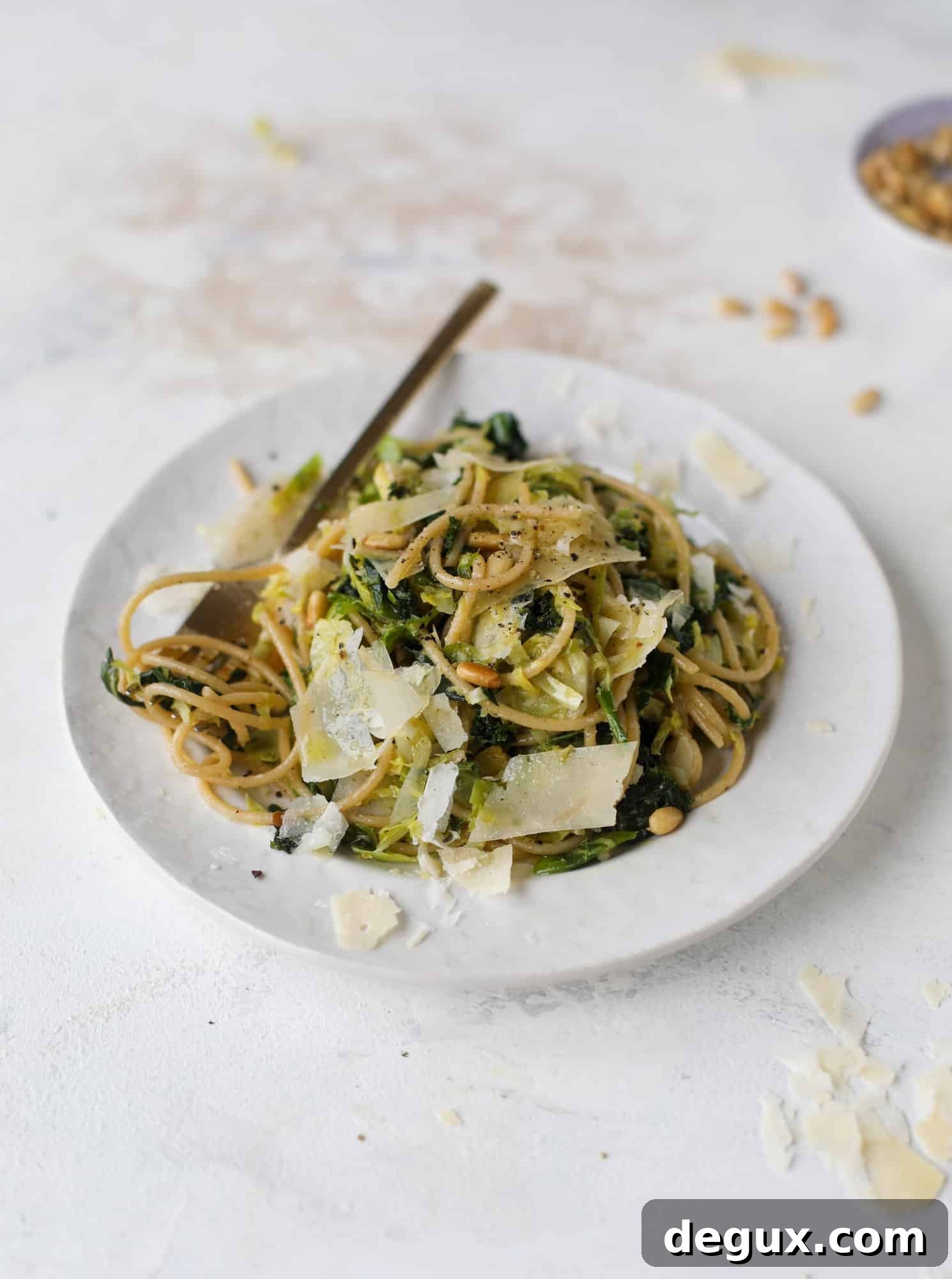 Brussels Sprouts and Kale Spaghetti with Parmesan & Pine Nuts 7 This brussels spaghetti with kale, parmesan and pine nuts is a super flavorful, quick and easy weeknight meal. You can add in a protein if you wish! I howsweeteats.com #brussels #spaghetti