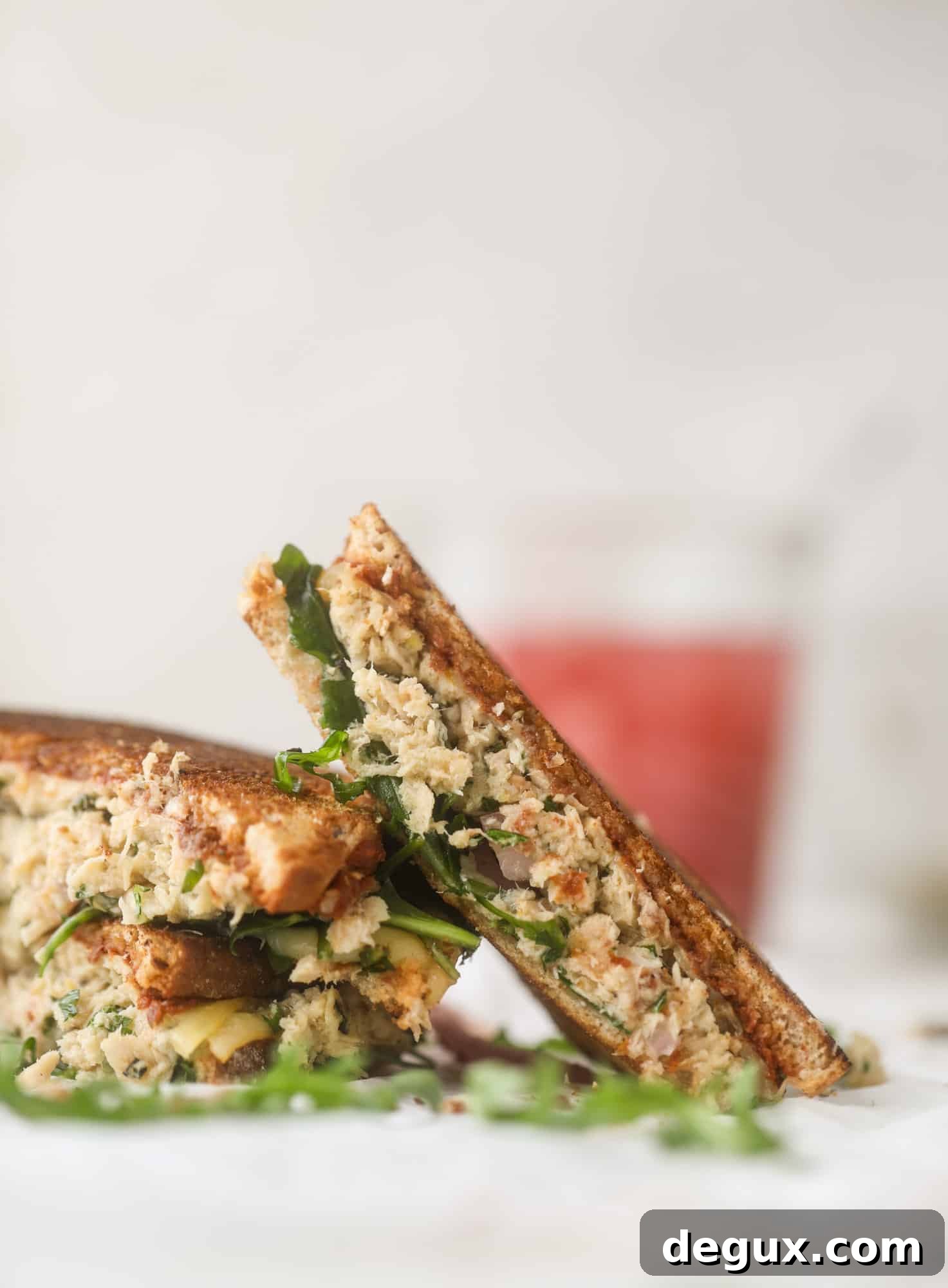 This tuscan tuna melt is a modern way to enjoy a tuna sandwich, with peppery arugula, melty cheese, pickled onions and sun dried tomato spread! I howsweeteats.com #tuna #melt
