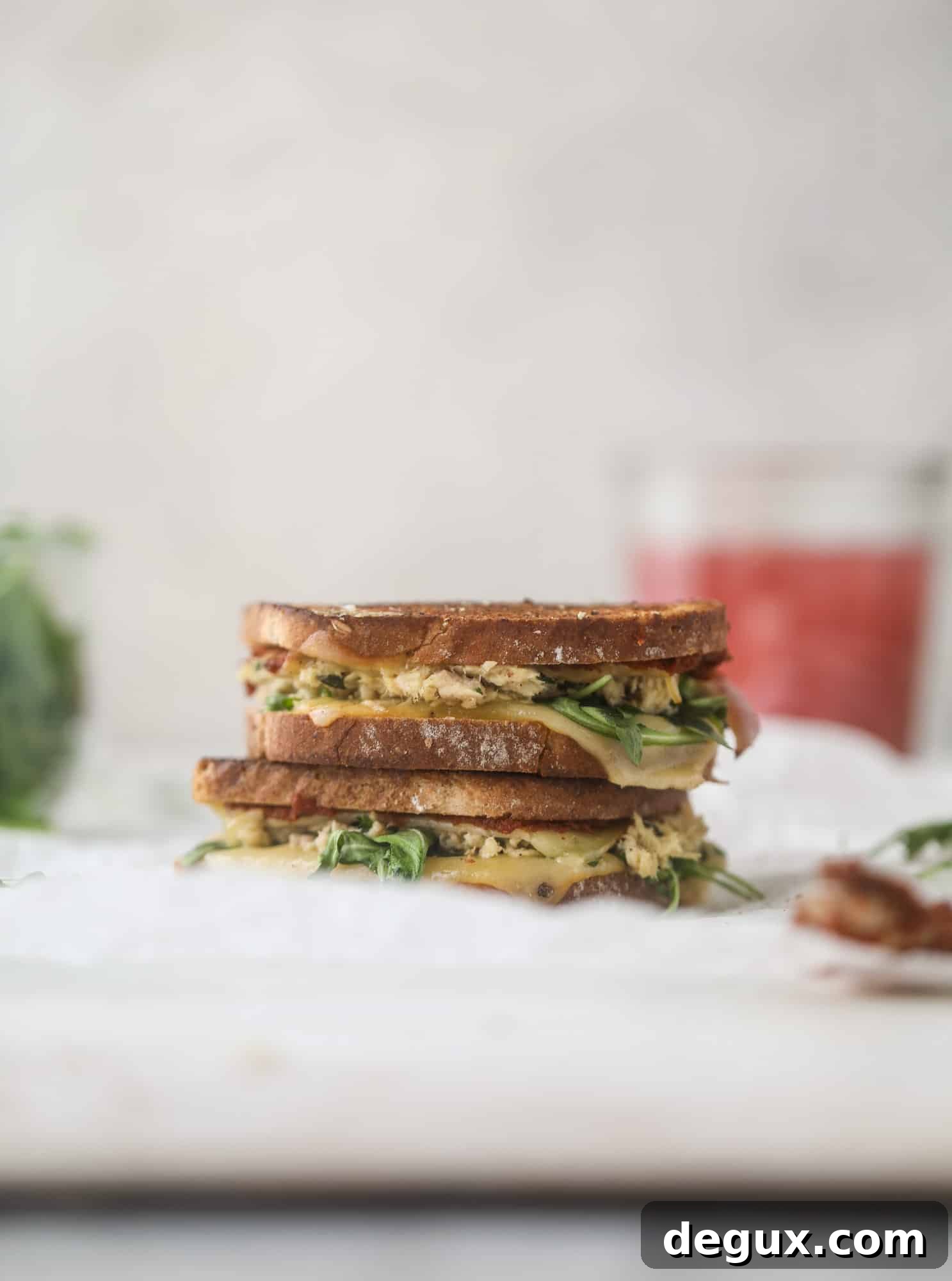 This tuscan tuna melt is a modern way to enjoy a tuna sandwich, with peppery arugula, melty cheese, pickled onions and sun dried tomato spread! I howsweeteats.com #tuna #melt