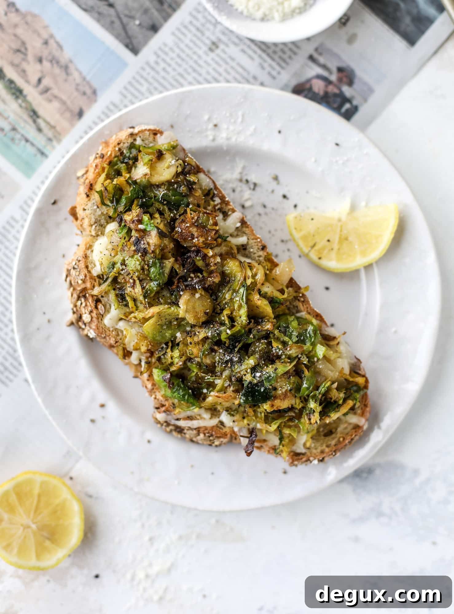 Crispy brussels sprouts toast begins with sourdough bread, melty havarti cheese and caramelized onions. It's high-maintenance toast in the best way possible. I howsweeteats.com