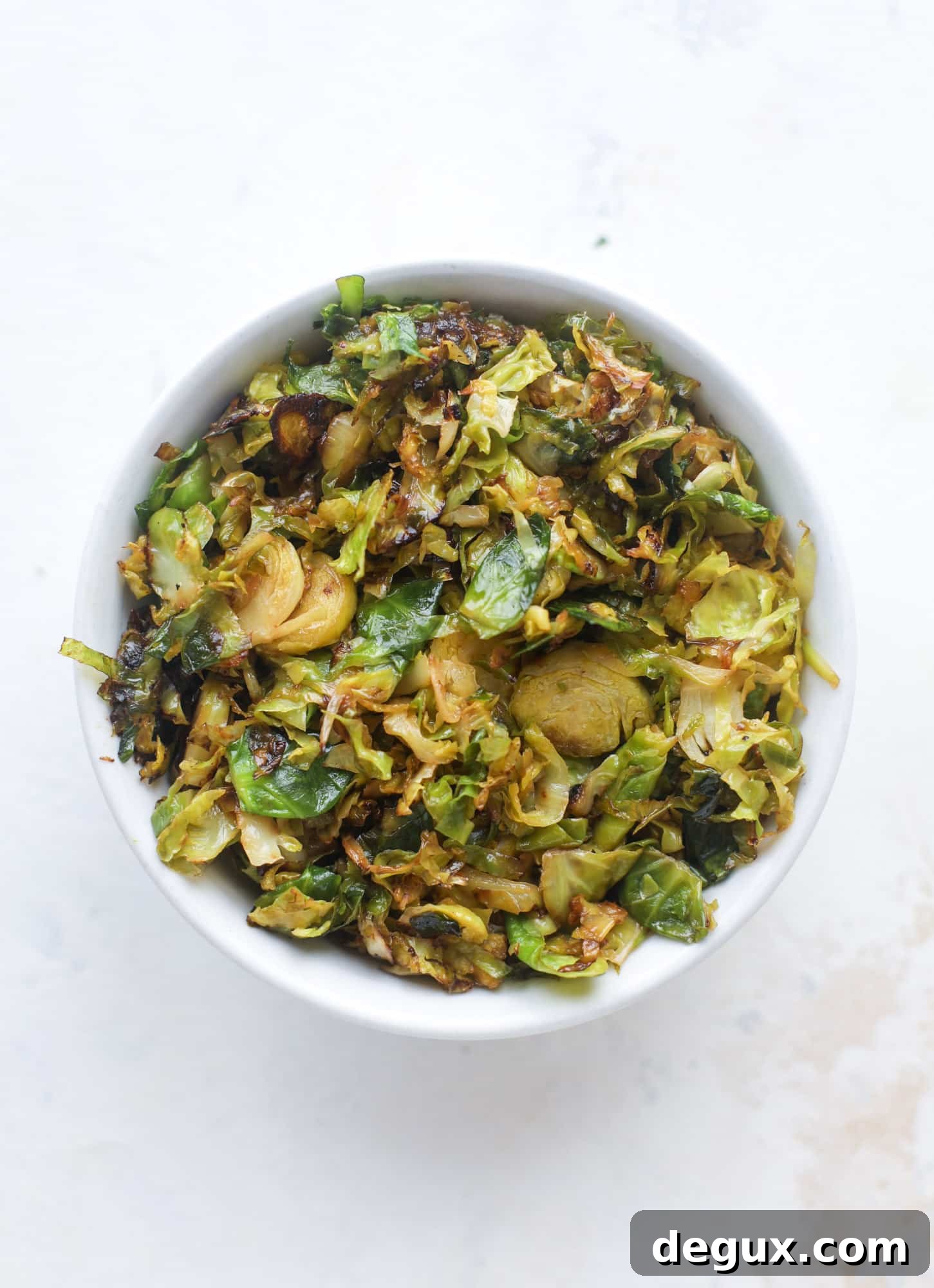 Crispy brussels sprouts toast begins with sourdough bread, melty havarti cheese and caramelized onions. It's high-maintenance toast in the best way possible. I howsweeteats.com