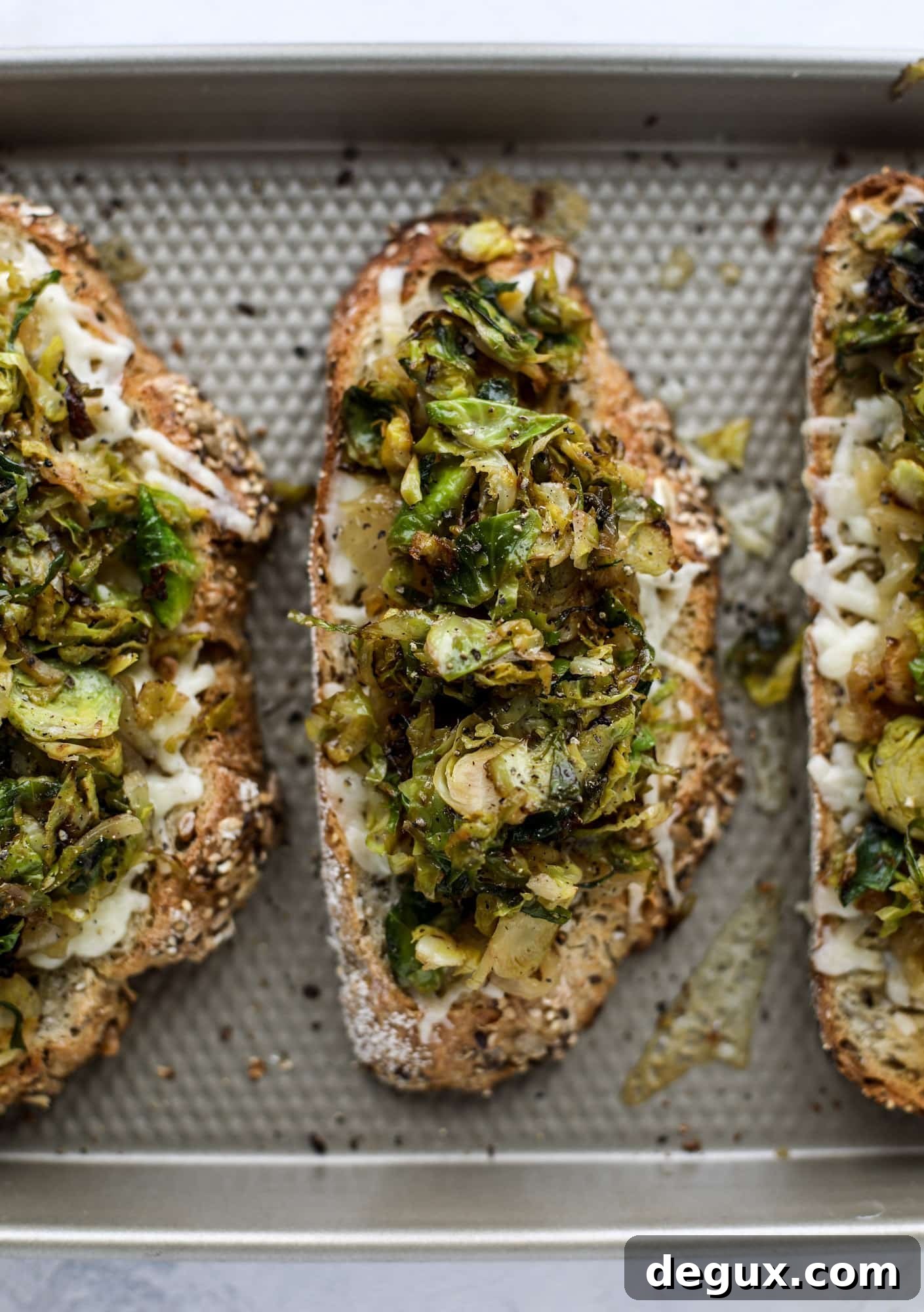 Crispy brussels sprouts toast begins with sourdough bread, melty havarti cheese and caramelized onions. It's high-maintenance toast in the best way possible. I howsweeteats.com