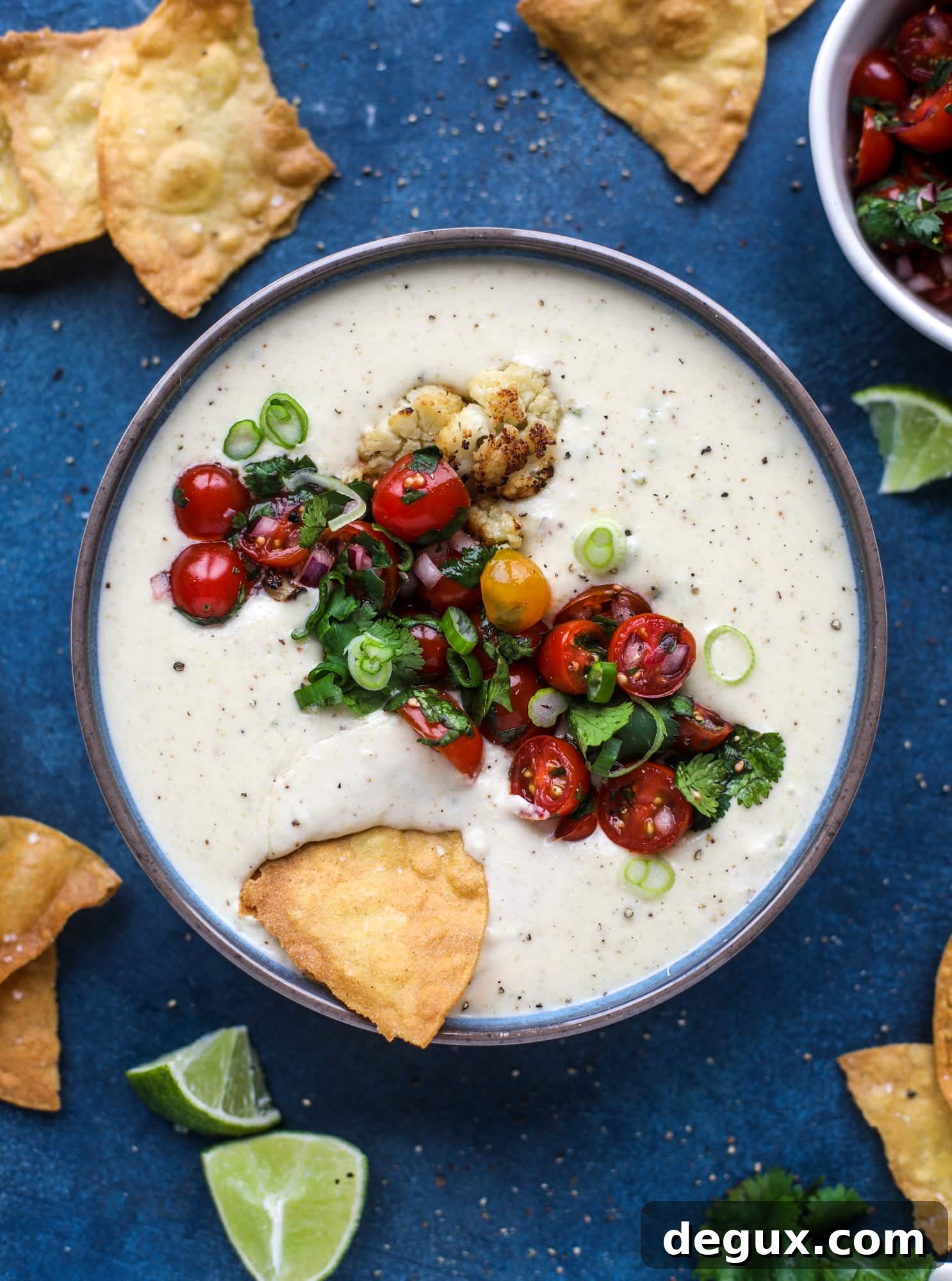 Roasted Cauliflower Queso Recipe: Creamy Vegan Dip for Parties 8 This roasted cauliflower queso has all the deliciousness of regular queso, with roasted cauliflower added in. It's satisfying and tastes like heaven. I howsweeteats.com #cauliflower #queso