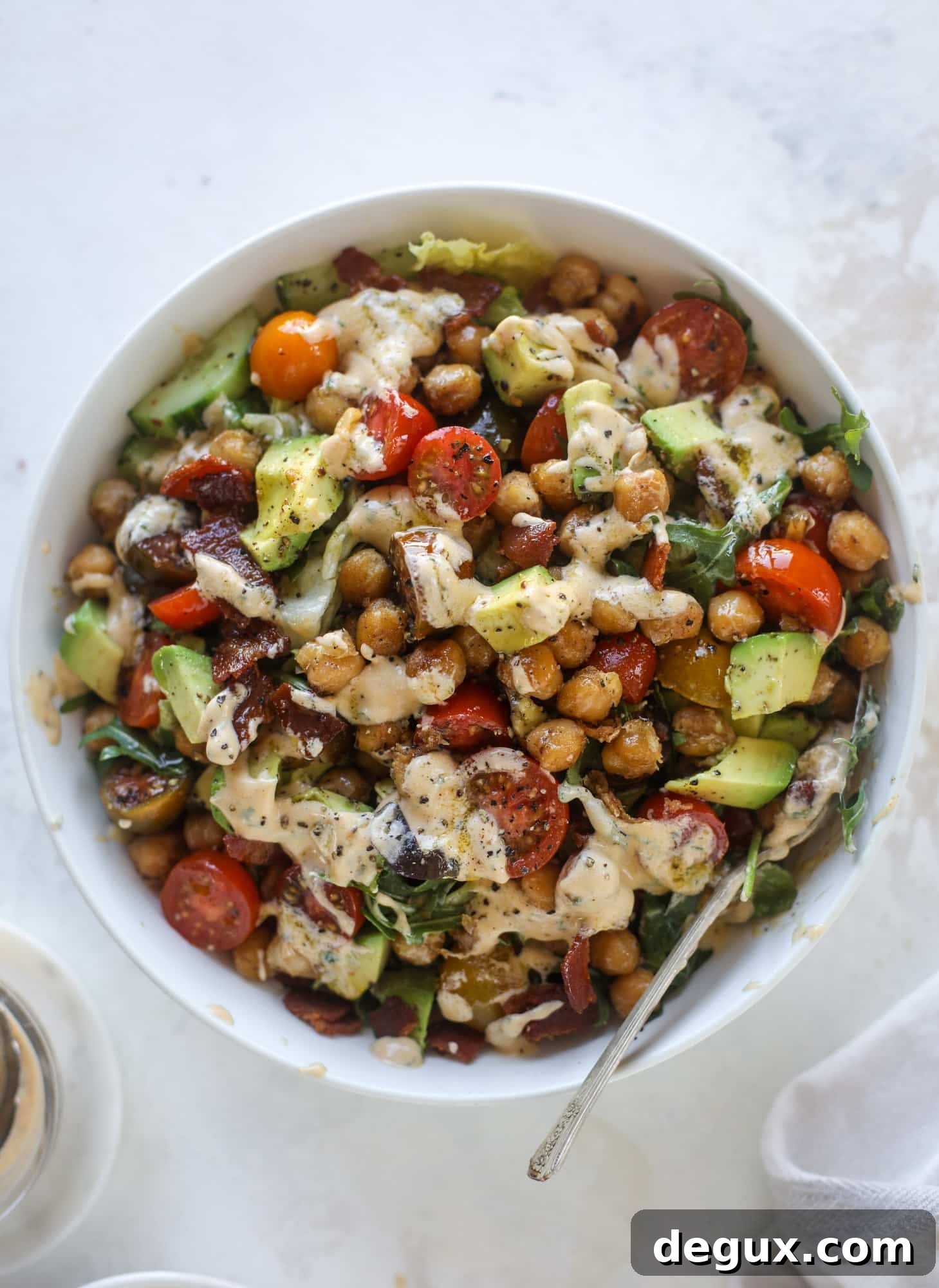 Chickpea Bacon Ranch Chopped Salad Recipe 2 The chickpea bacon ranch salad has a ton of crispy, crunchy texture and flavor. It's satisfying and super easy to prep ahead of time too! I howsweeteats.com #chickpea #salad