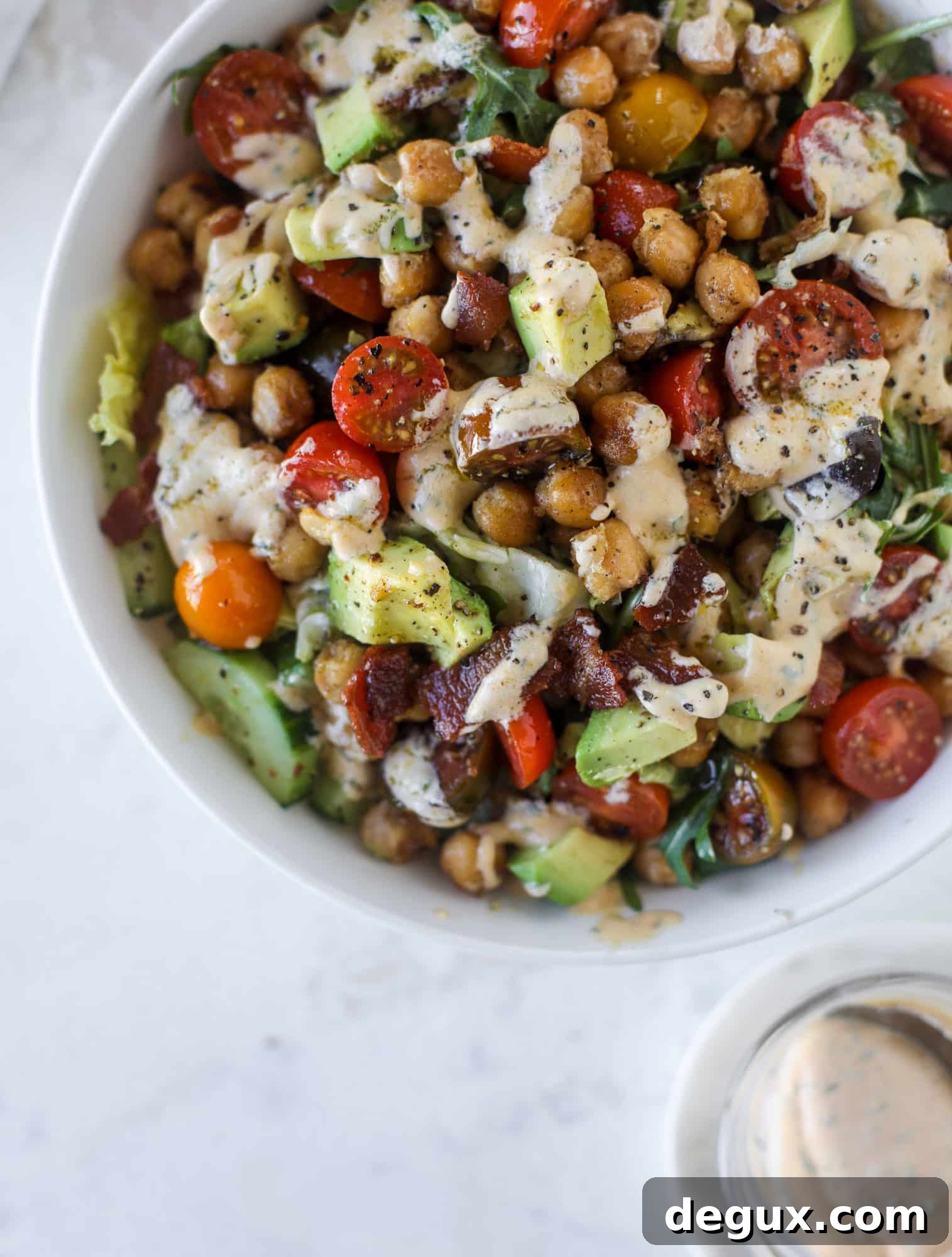 Chickpea Bacon Ranch Chopped Salad Recipe 9 The chickpea bacon ranch salad has a ton of crispy, crunchy texture and flavor. It's satisfying and super easy to prep ahead of time too! I howsweeteats.com #chickpea #salad