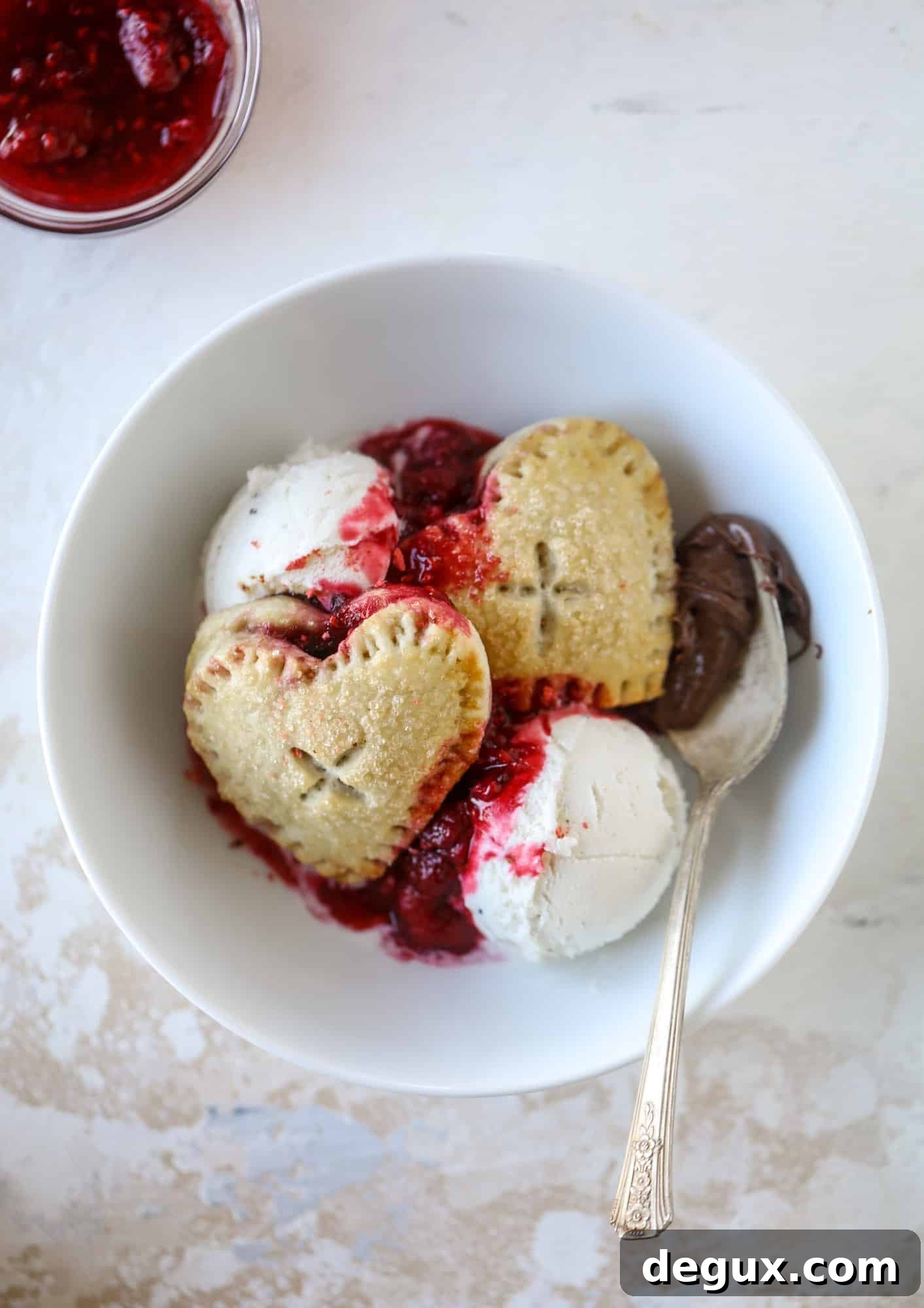 These adorable mini heart pies are filled with a homemade raspberry compote and creamy, chocolatey nutella. So fun and easy to make!