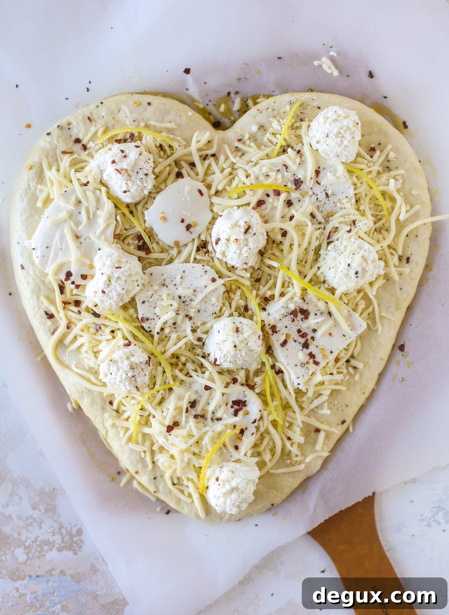 Our favorite white pizza recipe has four different kinds of cheese and comes on a garlic bread crust! Topped with crushed pepper and lemon - tons of flavor!