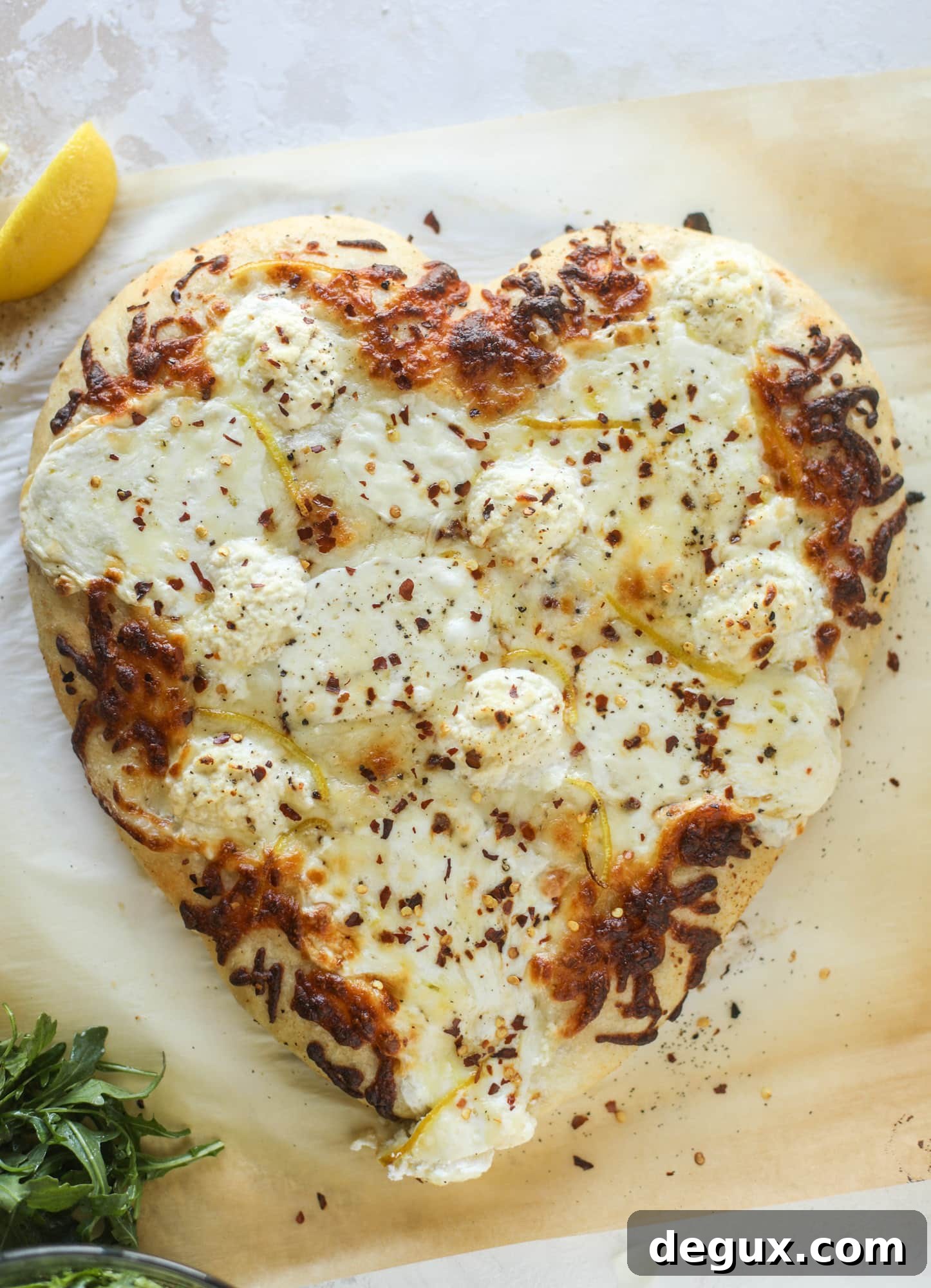 Our favorite white pizza recipe has four different kinds of cheese and comes on a garlic bread crust! Topped with crushed pepper and lemon - tons of flavor!