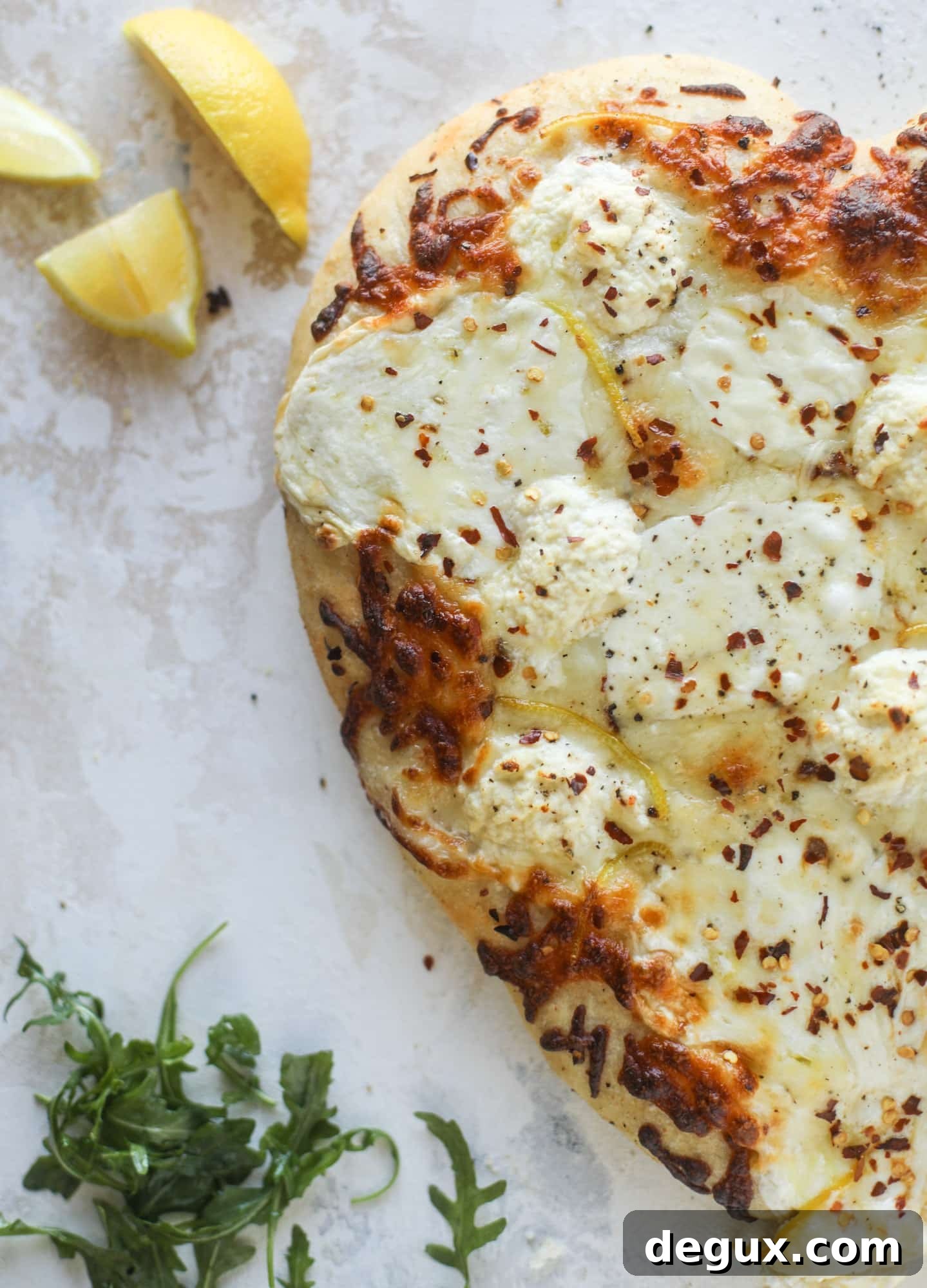 Our favorite white pizza recipe has four different kinds of cheese and comes on a garlic bread crust! Topped with crushed pepper and lemon - tons of flavor!