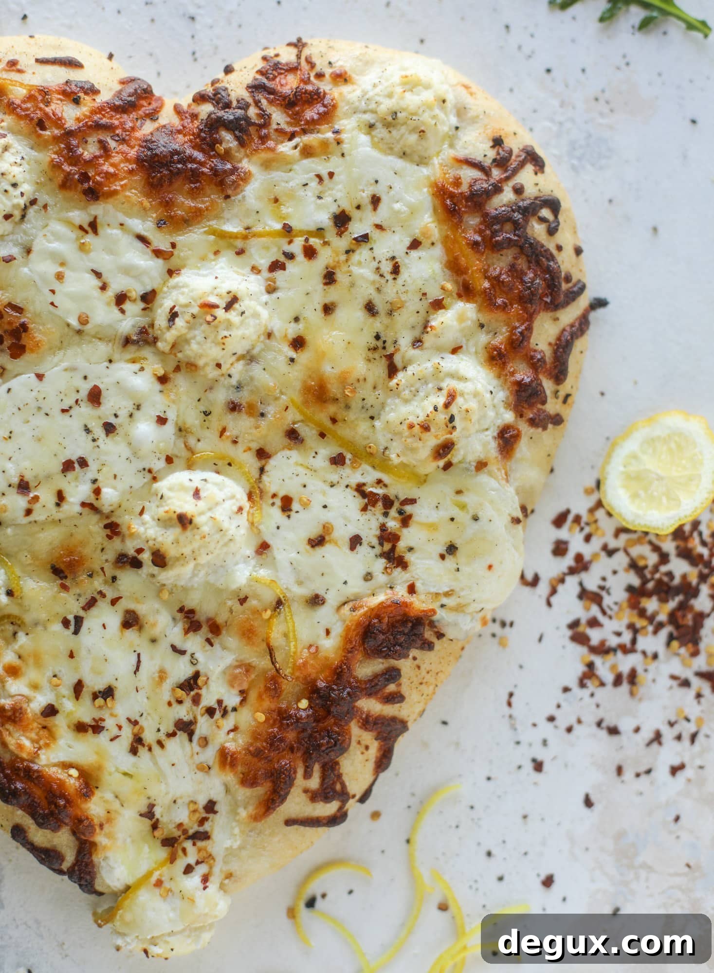 Our favorite white pizza recipe has four different kinds of cheese and comes on a garlic bread crust! Topped with crushed pepper and lemon - tons of flavor!