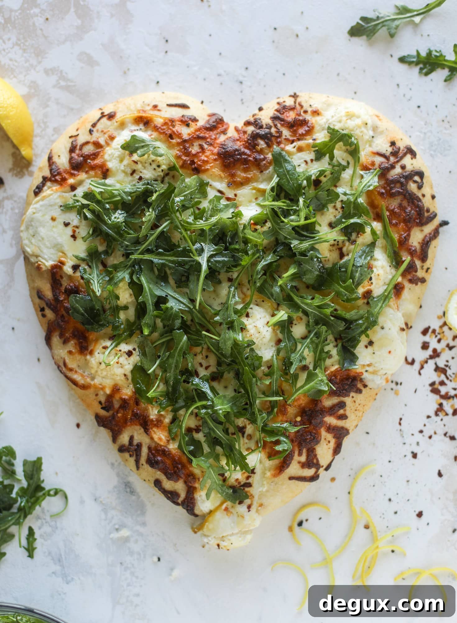 Our favorite white pizza recipe has four different kinds of cheese and comes on a garlic bread crust! Topped with crushed pepper and lemon - tons of flavor!