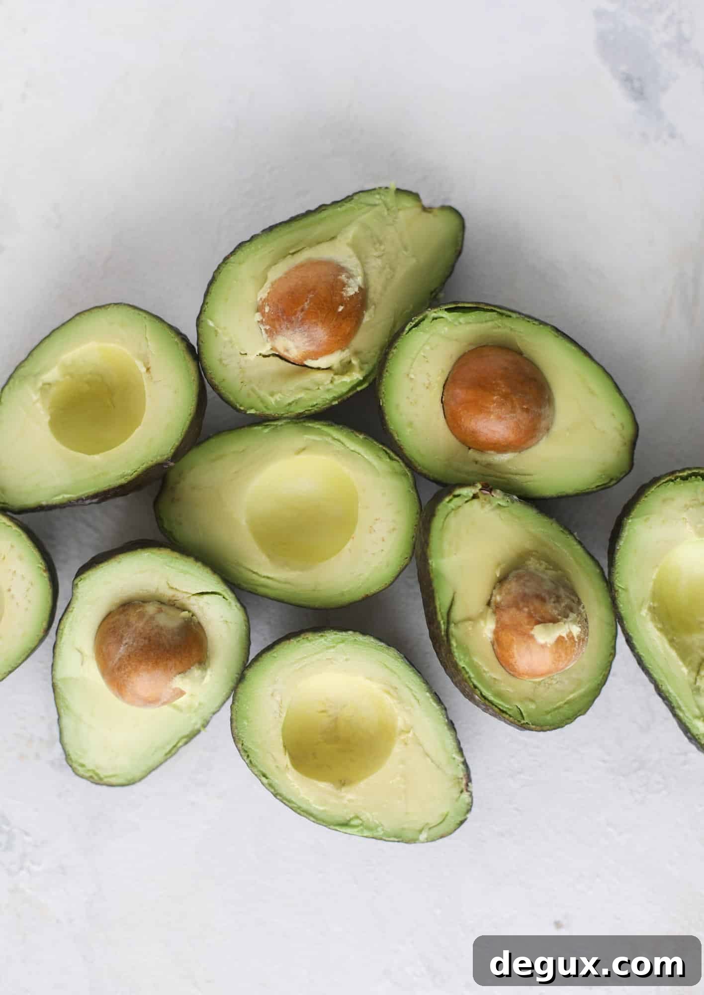 These baked avocados are stuffed with a cheesy chicken mixture and drizzled with sriracha yogurt sauce! Super delicious and an easy weeknight meal.