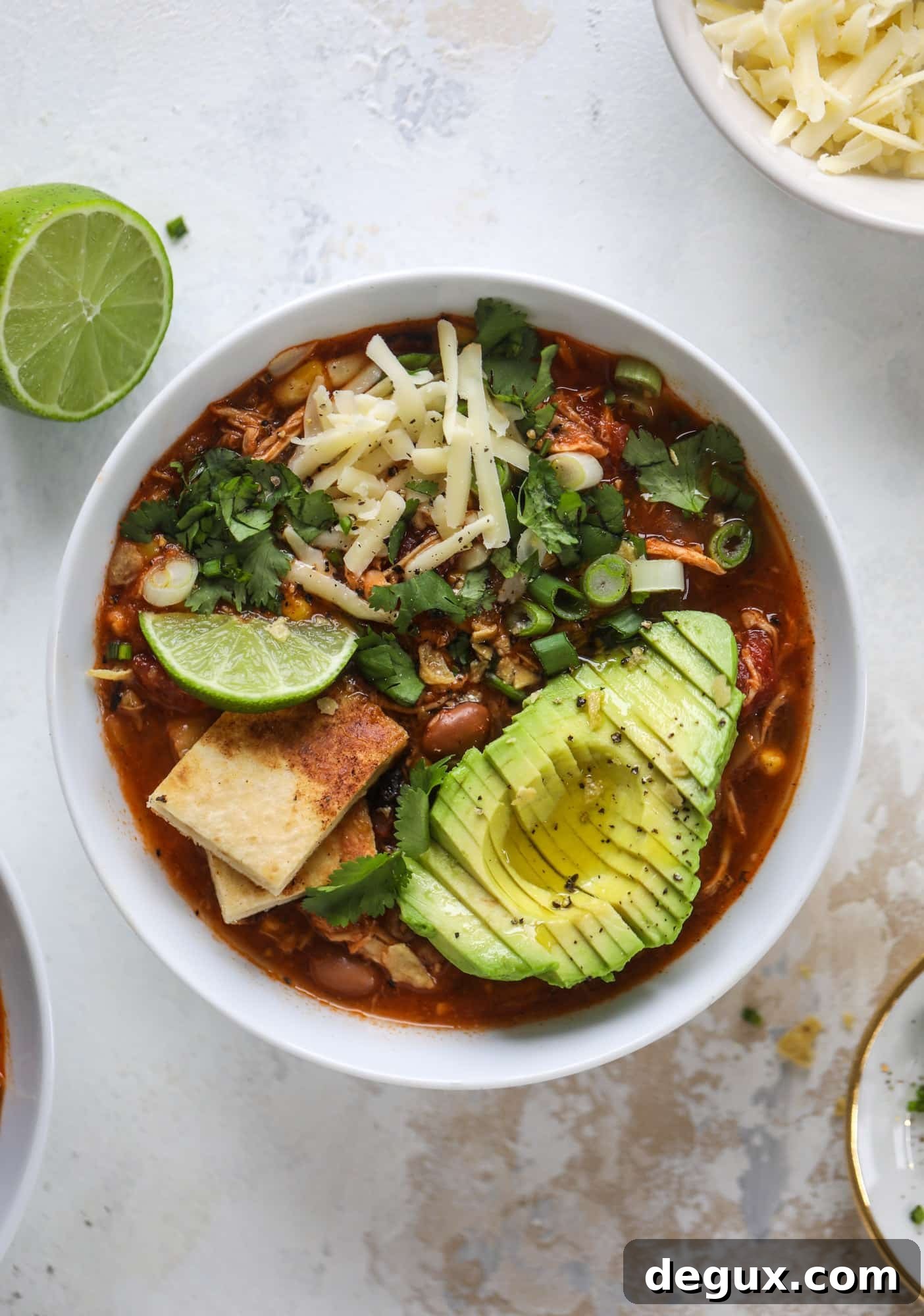 This flavorful chicken taco soup can be made on the stovetop or in the slow cooker. It's hearty and topped with cheese quesadilla croutons!