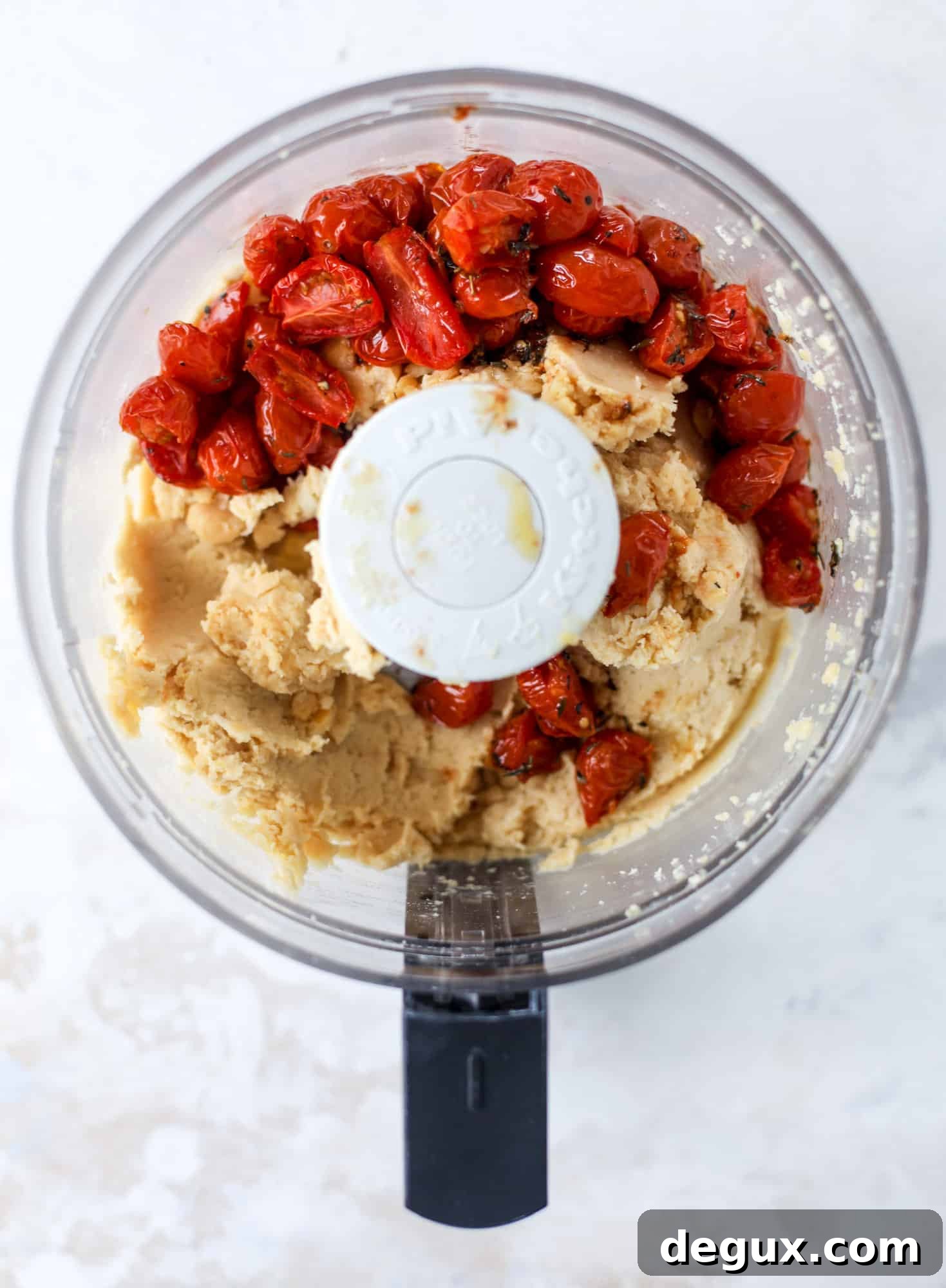 Slow roasted tomato hummus is a creamy and savory spread that is perfect for dipping, sandwiches or wraps, salads and bowls of all kind! I howsweeteats.com #slowroastedtomato #hummus