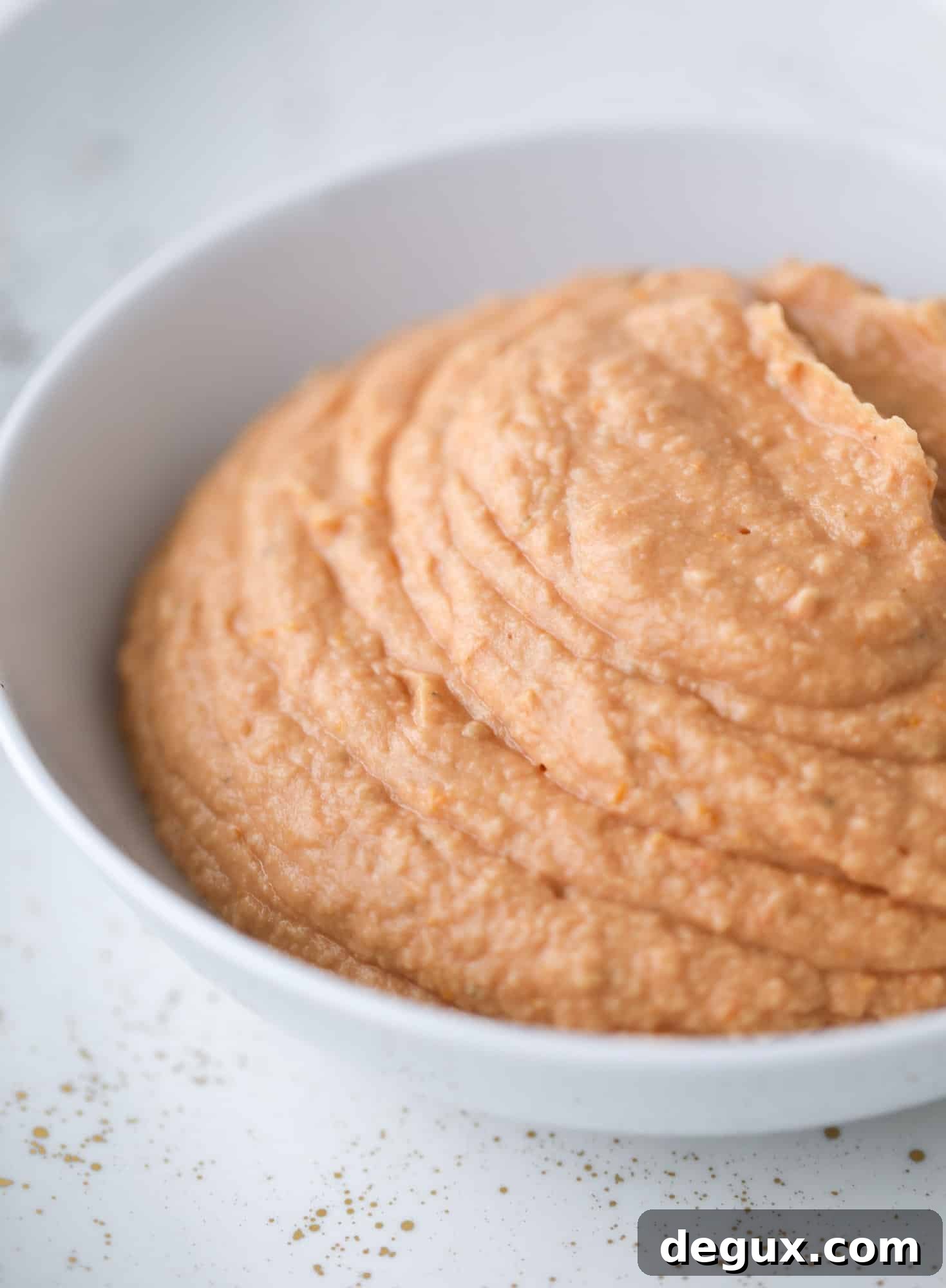 Slow roasted tomato hummus is a creamy and savory spread that is perfect for dipping, sandwiches or wraps, salads and bowls of all kind! I howsweeteats.com #slowroastedtomato #hummus
