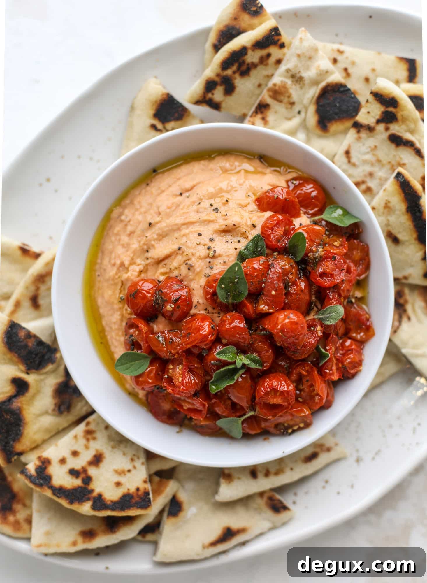 Slow roasted tomato hummus is a creamy and savory spread that is perfect for dipping, sandwiches or wraps, salads and bowls of all kind! I howsweeteats.com #slowroastedtomato #hummus