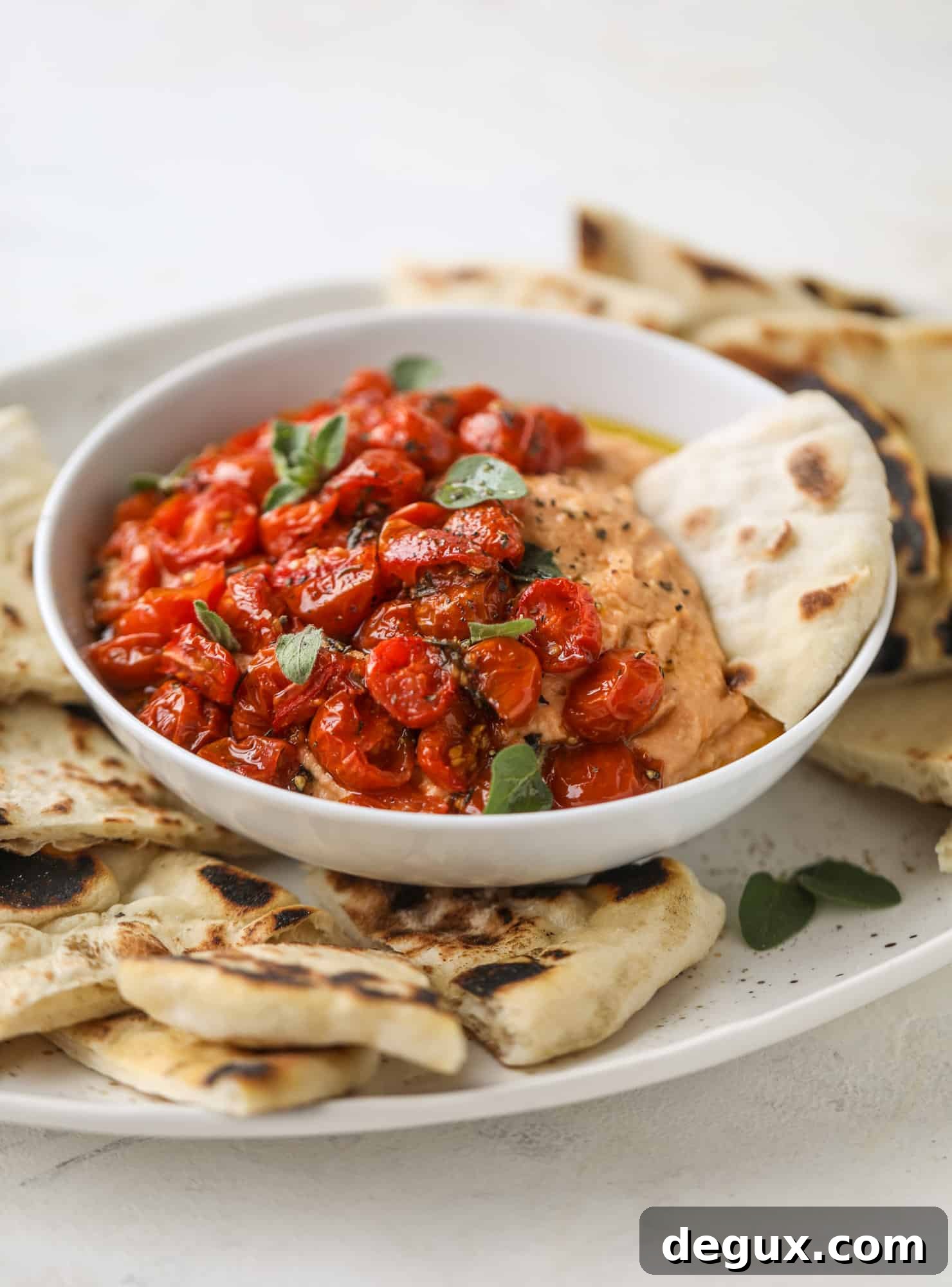 Slow roasted tomato hummus is a creamy and savory spread that is perfect for dipping, sandwiches or wraps, salads and bowls of all kind! I howsweeteats.com #slowroastedtomato #hummus
