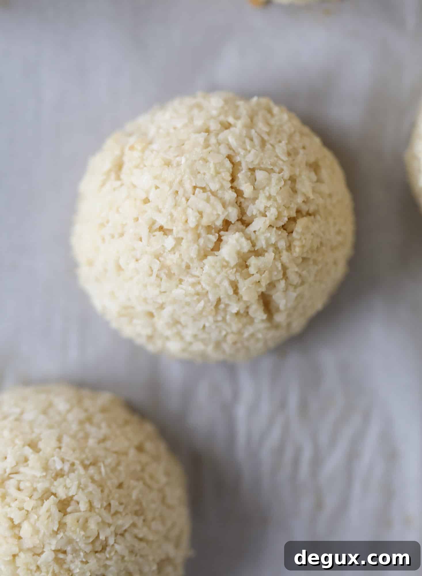 Classic chewy, slightly gooey coconut macaroons dipped in an irish cream chocolate ganache. Easy to make and gluten free too! I howsweeteats.com #irishcream #coconutmacaroons