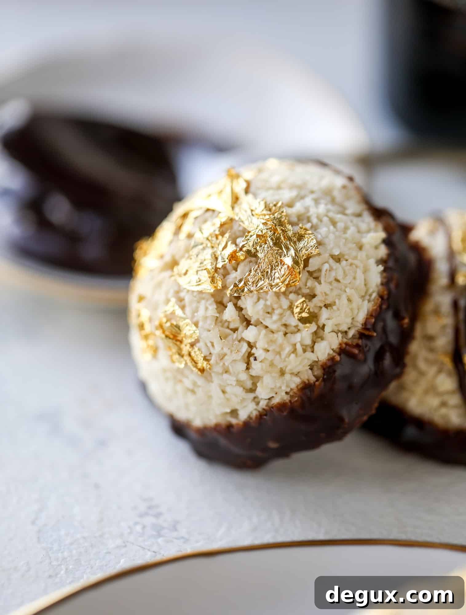 Classic chewy, slightly gooey coconut macaroons dipped in an irish cream chocolate ganache. Easy to make and gluten free too! I howsweeteats.com #irishcream #coconutmacaroons