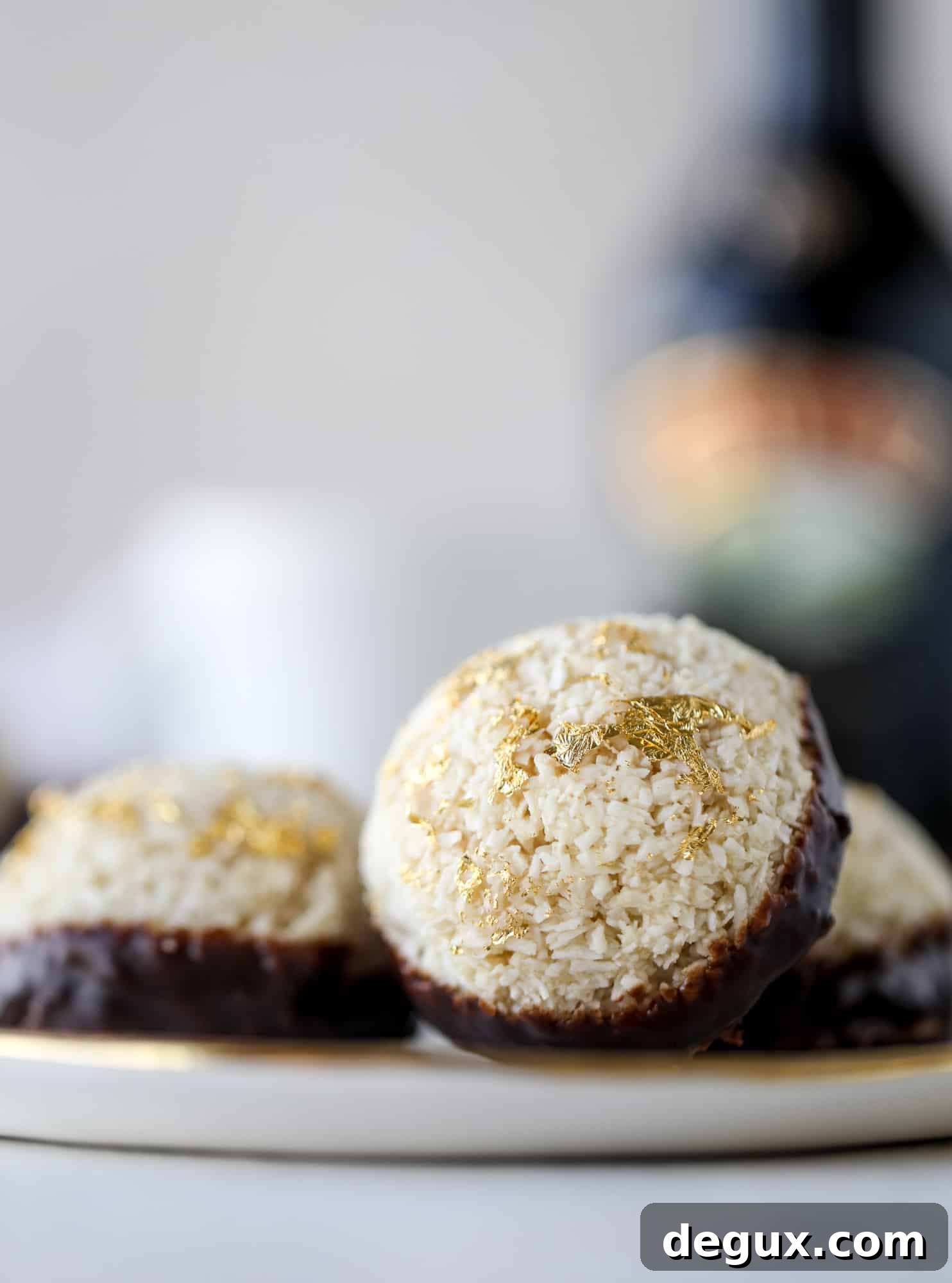 Classic chewy, slightly gooey coconut macaroons dipped in an irish cream chocolate ganache. Easy to make and gluten free too! I howsweeteats.com #irishcream #coconutmacaroons