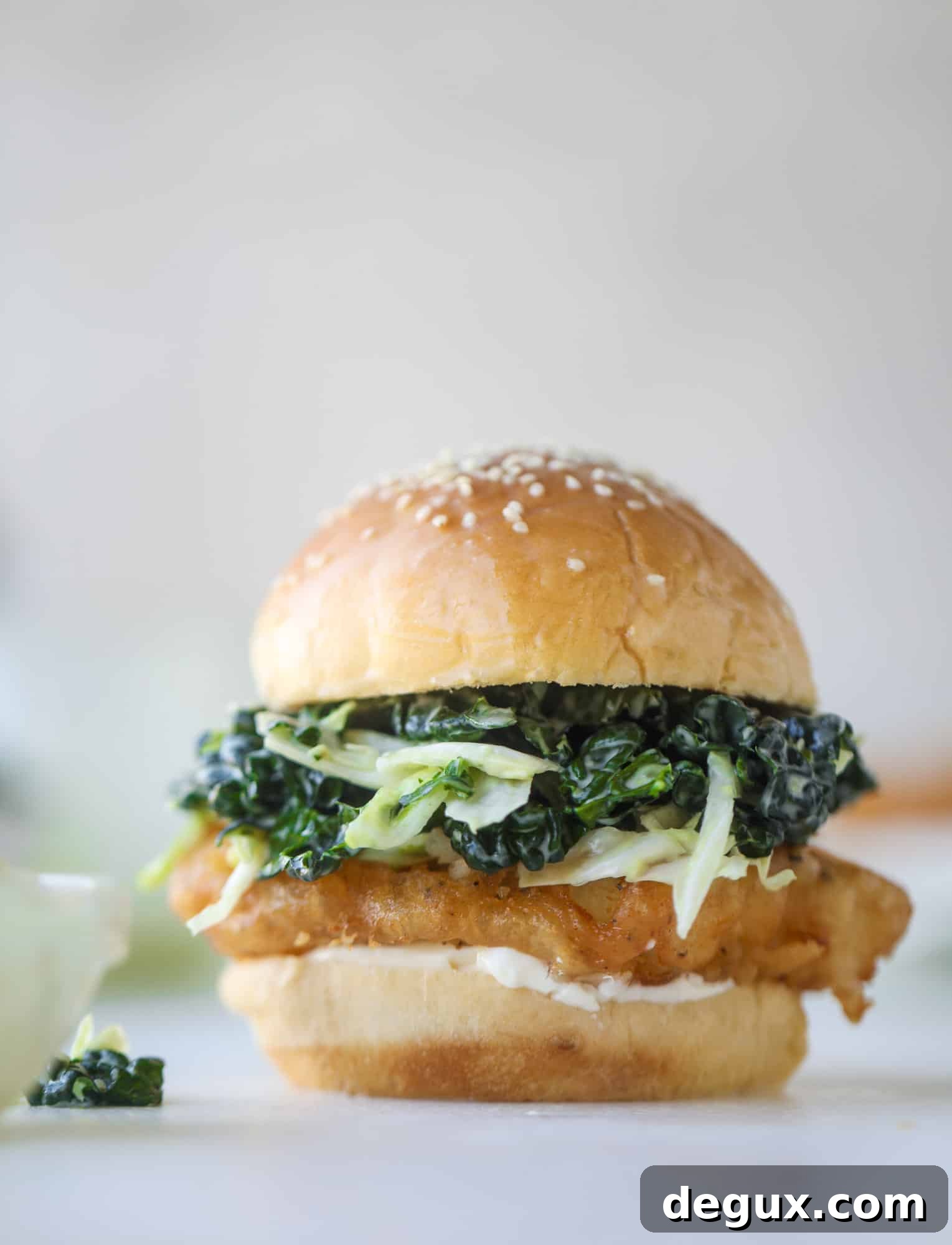 Crispy Fish Sandwich with Kale Coleslaw Recipe 11 A light and crispy fish sandwich made with a simple beer batter and topped with a hearty, creamy kale cole slaw. Loaded with flavor! I howsweeteats.com #crispyfish #sandwich