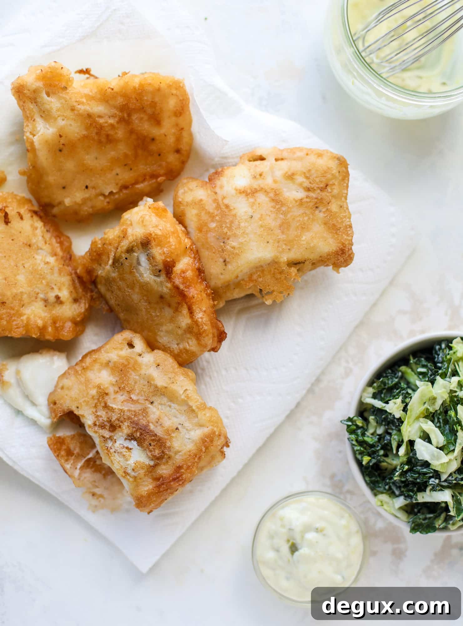 Crispy Fish Sandwich with Kale Coleslaw Recipe 6 A light and crispy fish sandwich made with a simple beer batter and topped with a hearty, creamy kale cole slaw. Loaded with flavor! I howsweeteats.com #crispyfish #sandwich