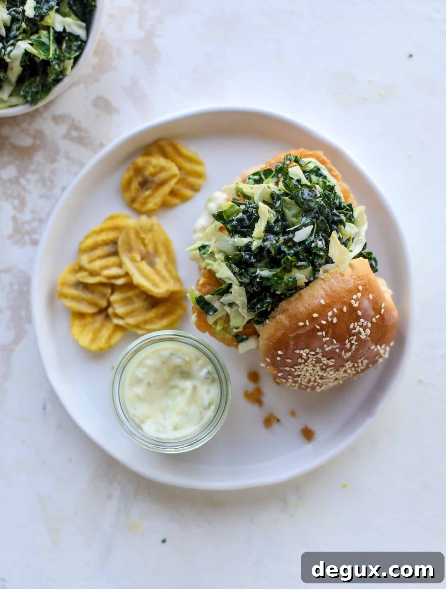 Crispy Fish Sandwich with Kale Coleslaw Recipe 9 A light and crispy fish sandwich made with a simple beer batter and topped with a hearty, creamy kale cole slaw. Loaded with flavor! I howsweeteats.com #crispyfish #sandwich