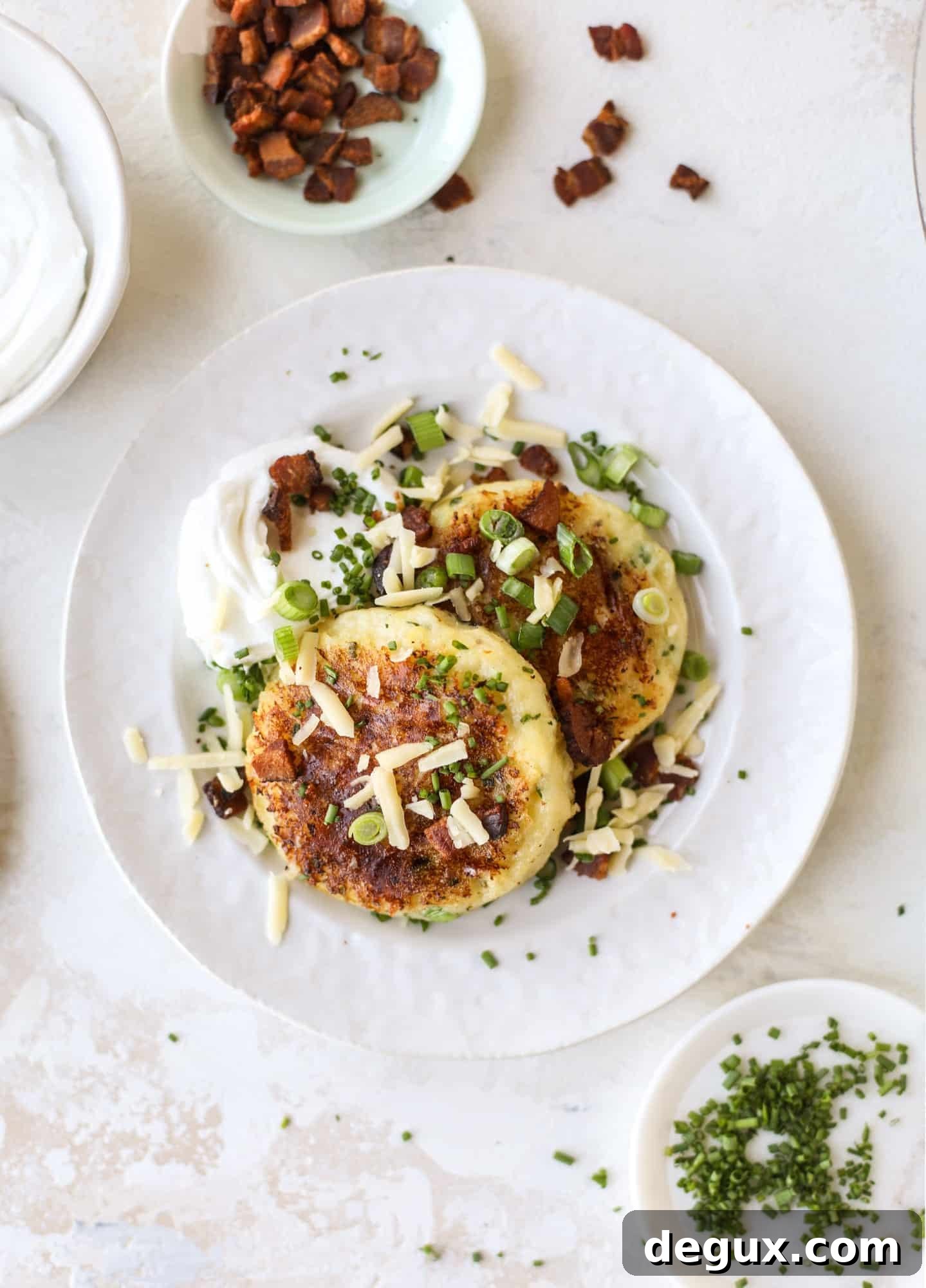 Loaded-mashed potato pancakes are the perfect comfort food or side dish to a hearty meat. Crispy mashed potatoes with aged cheddar. Delicious! I howsweeteats.com #mashedpotato #pancakes