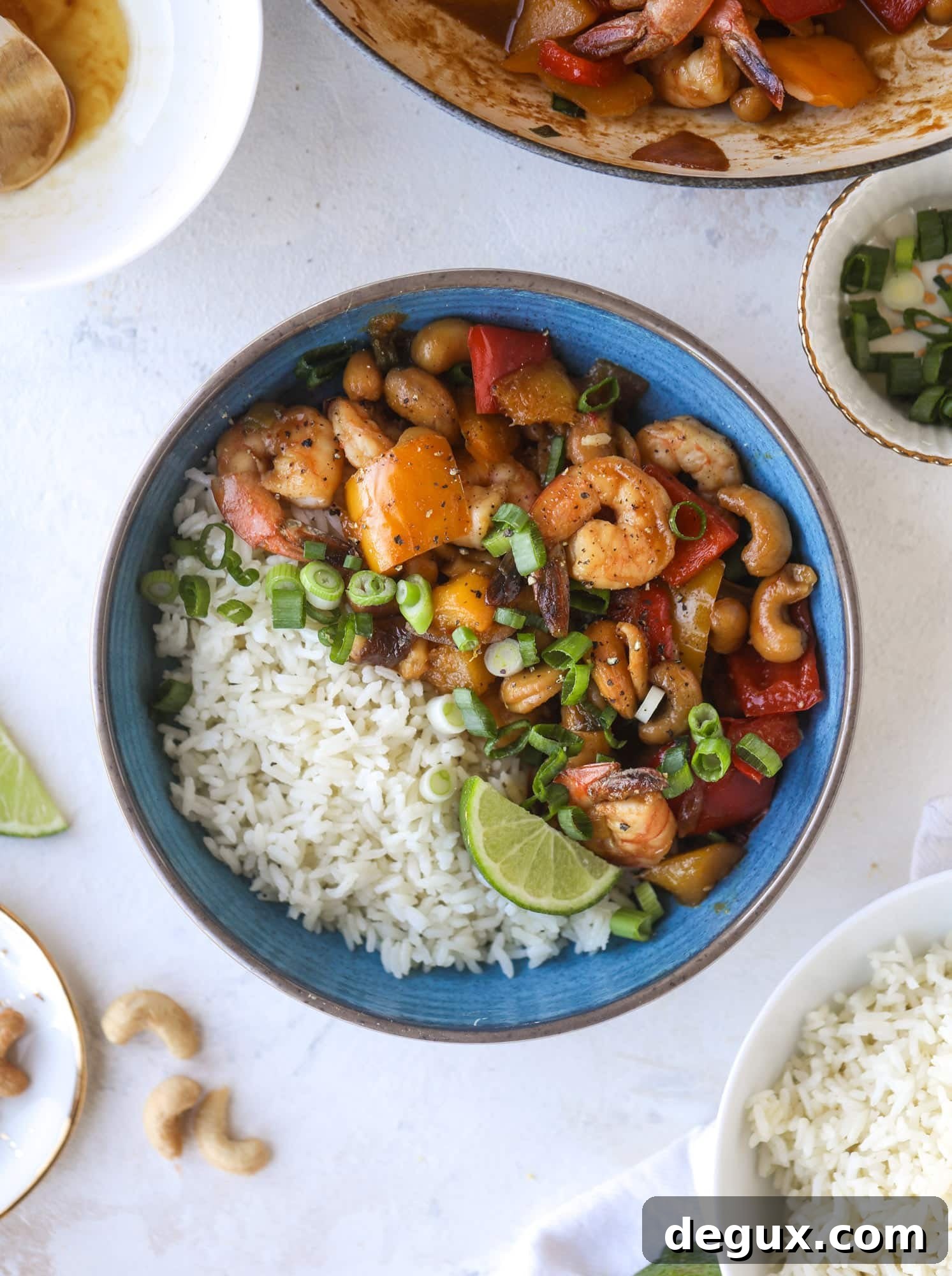 This cashew shrimp stir fry is a super simple weeknight meal! Made with bell peppers and mango, it is delicious over rice and comes together in 25 minutes. I howsweeteats.com #cashew #shrimp