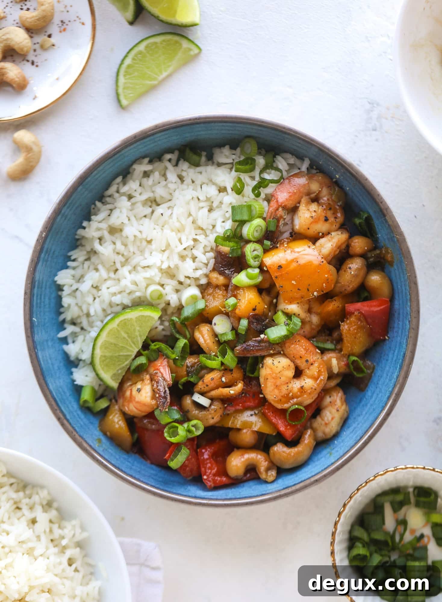 This cashew shrimp stir fry is a super simple weeknight meal! Made with bell peppers and mango, it is delicious over rice and comes together in 25 minutes. I howsweeteats.com #cashew #shrimp