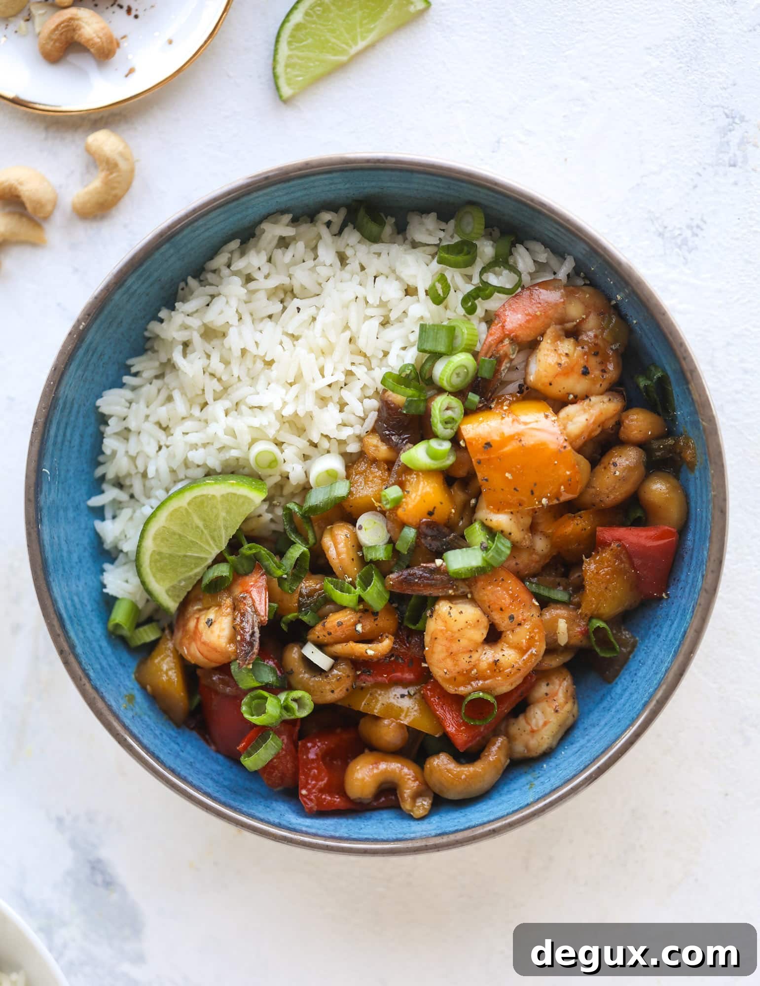 This cashew shrimp stir fry is a super simple weeknight meal! Made with bell peppers and mango, it is delicious over rice and comes together in 25 minutes. I howsweeteats.com #cashew #shrimp