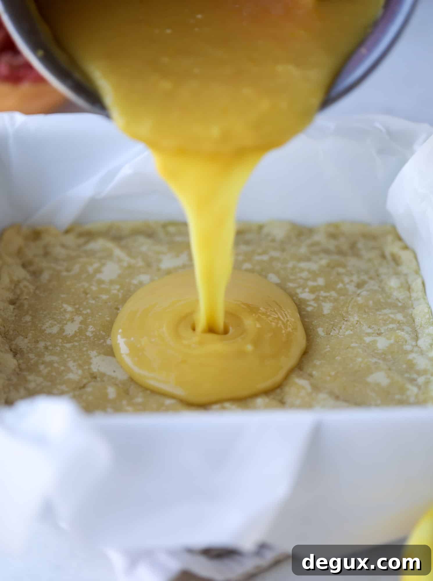 Salted Citrus Dessert Bars with Sea Salt Glaze 4 pouring curd into shortbread crust