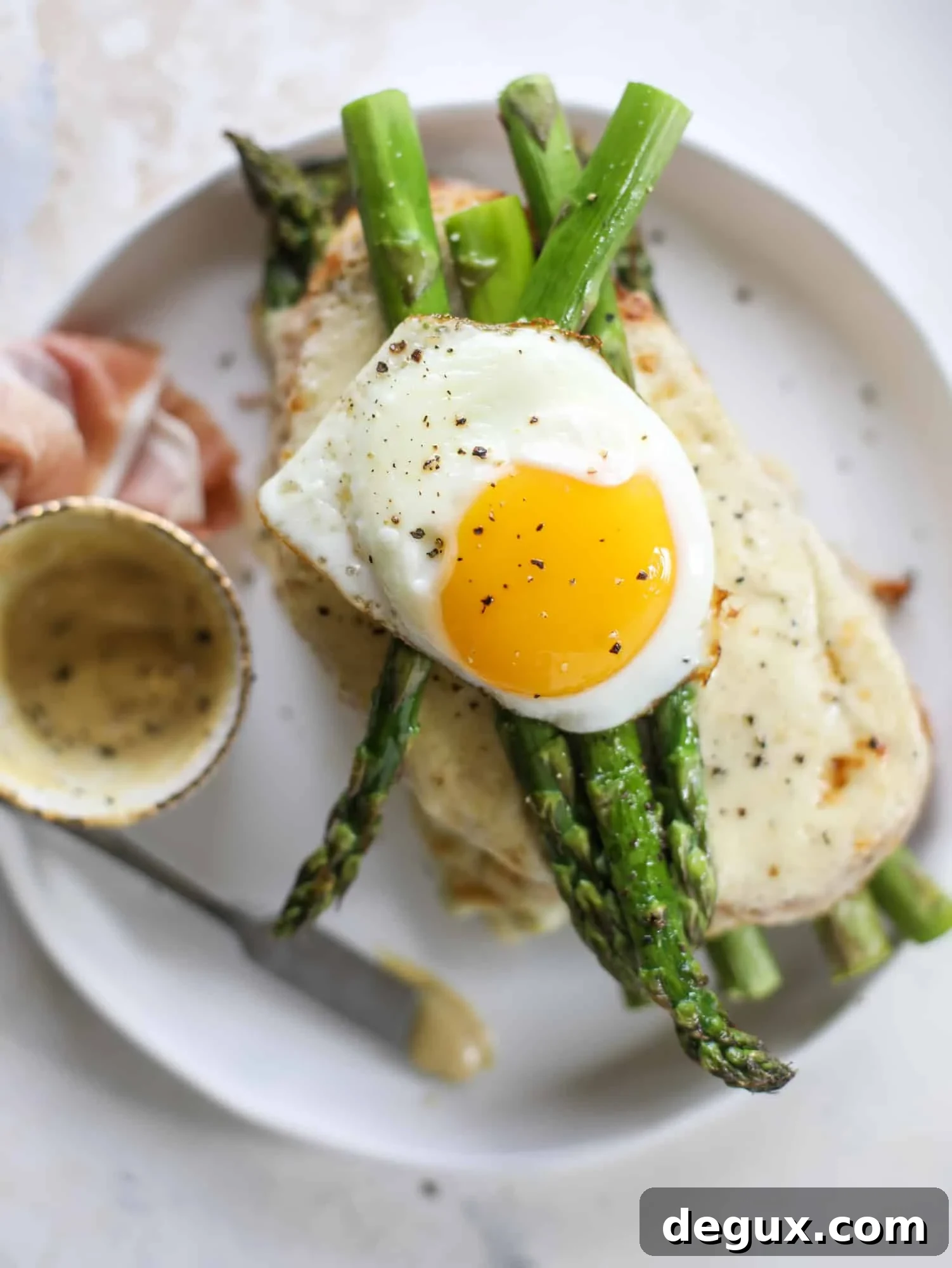 Roasted Asparagus and Prosciutto Croque-Madame Recipe 8 This roasted asparagus croque madame is made with thinly-sliced prosciutto and a fontina cheese sauce. Lots of dijon and an egg on top!