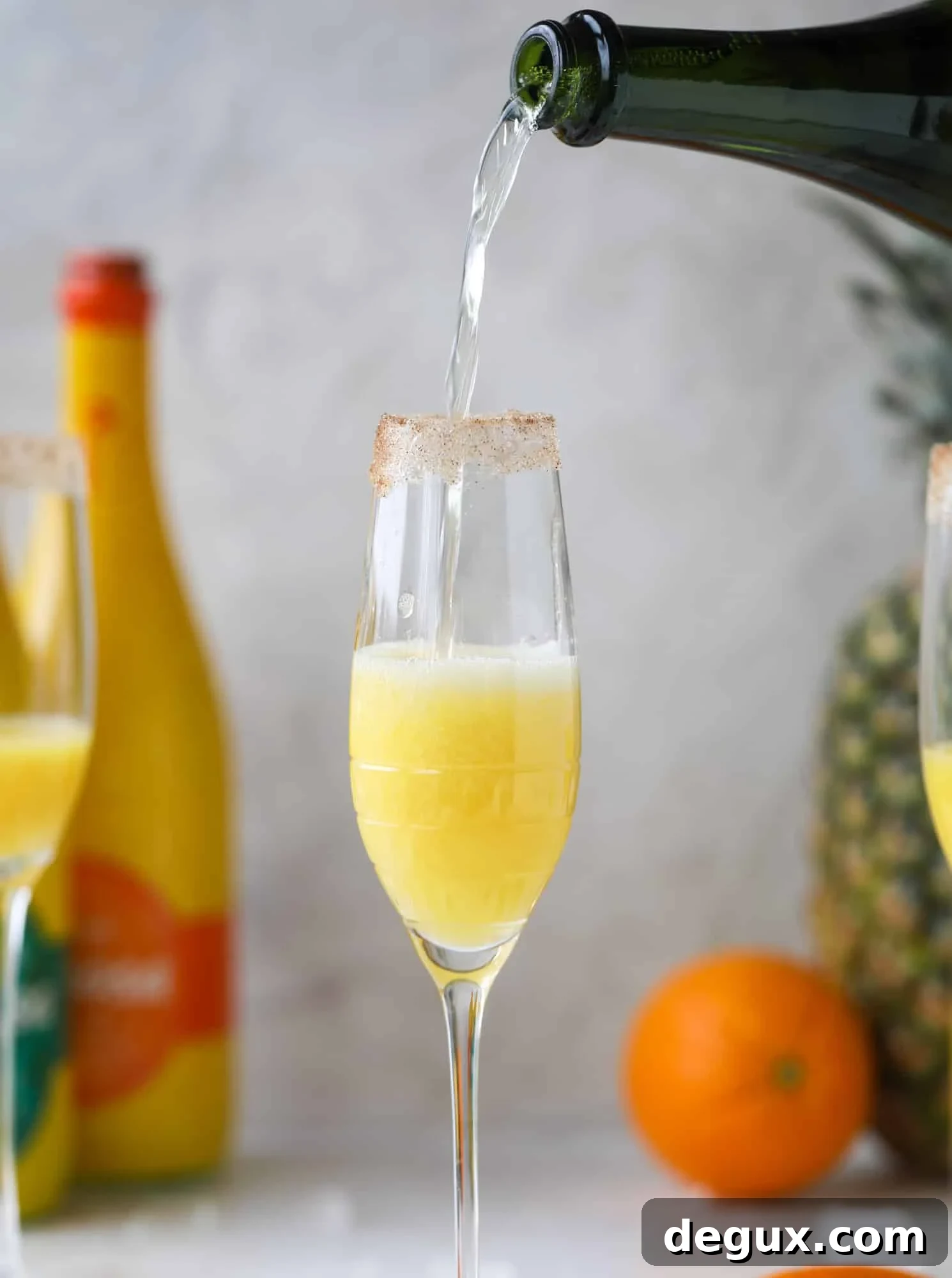 Hummingbird Mimosa Cocktail Recipe for Spring Brunch 6 champagne pour into a mimosa