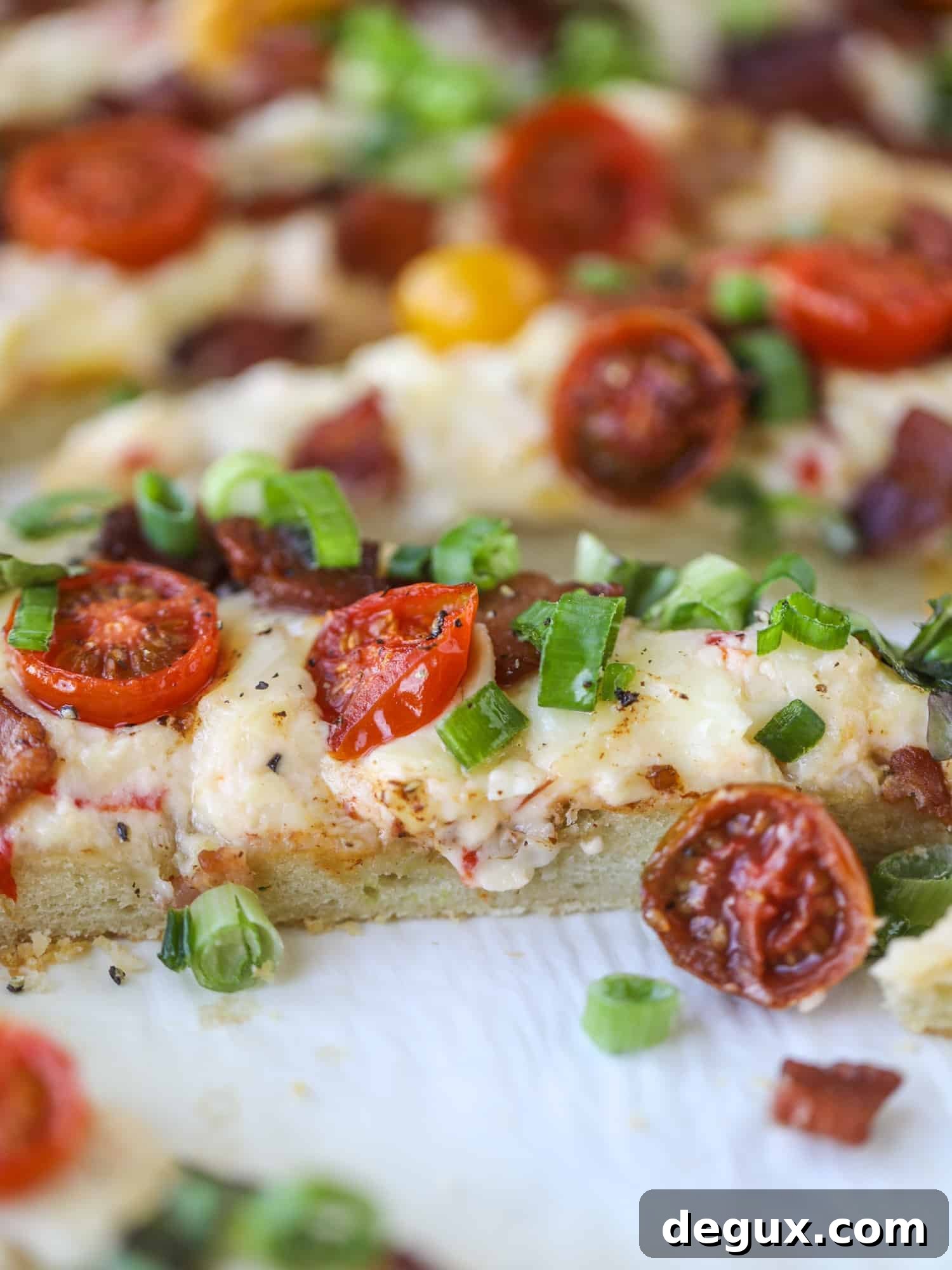 A crisped flatbread crust is topped with creamy pimento cheese, crispy bacon, garlic burst tomatoes and shredded lettuce. It's a flavor explosion!