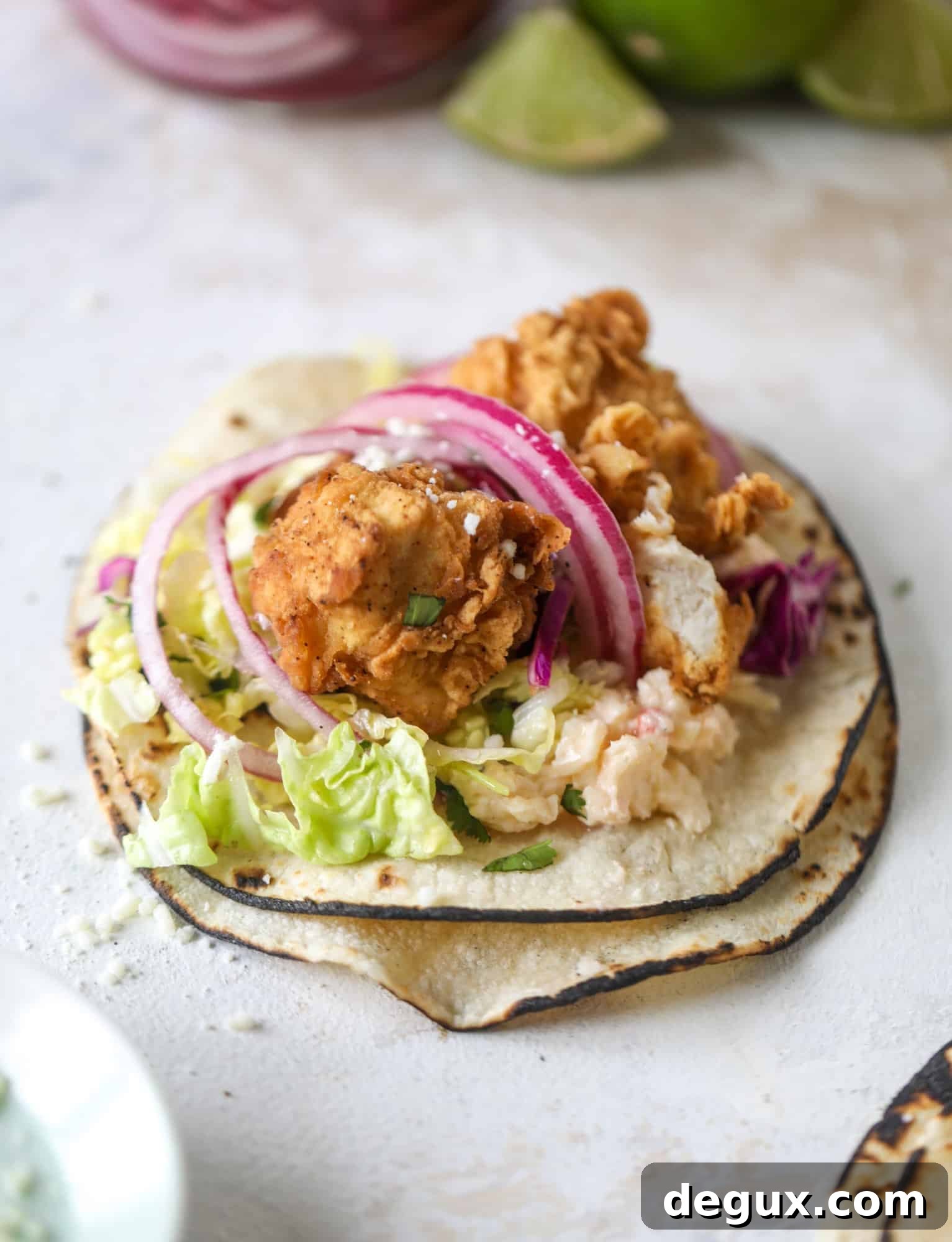 Crispy Chicken Tacos with Gouda and Pimento Cheese 6 Taking crispy chicken tacos to the next level by wrapping them in a warm tortilla with gouda pimento cheese, lime cabbage and pickled onions!