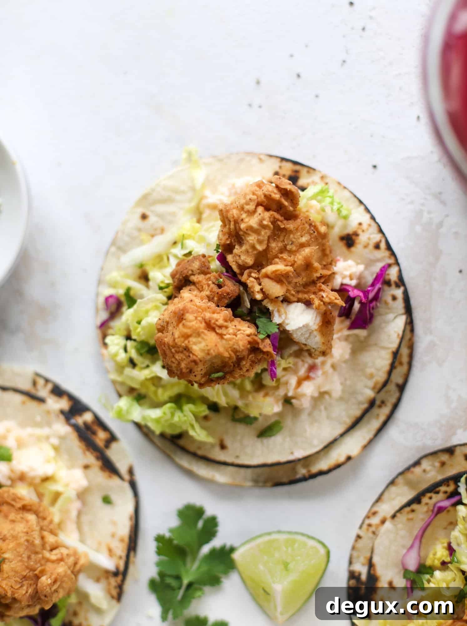 Crispy Chicken Tacos with Gouda and Pimento Cheese 9 Taking crispy chicken tacos to the next level by wrapping them in a warm tortilla with gouda pimento cheese, lime cabbage and pickled onions!