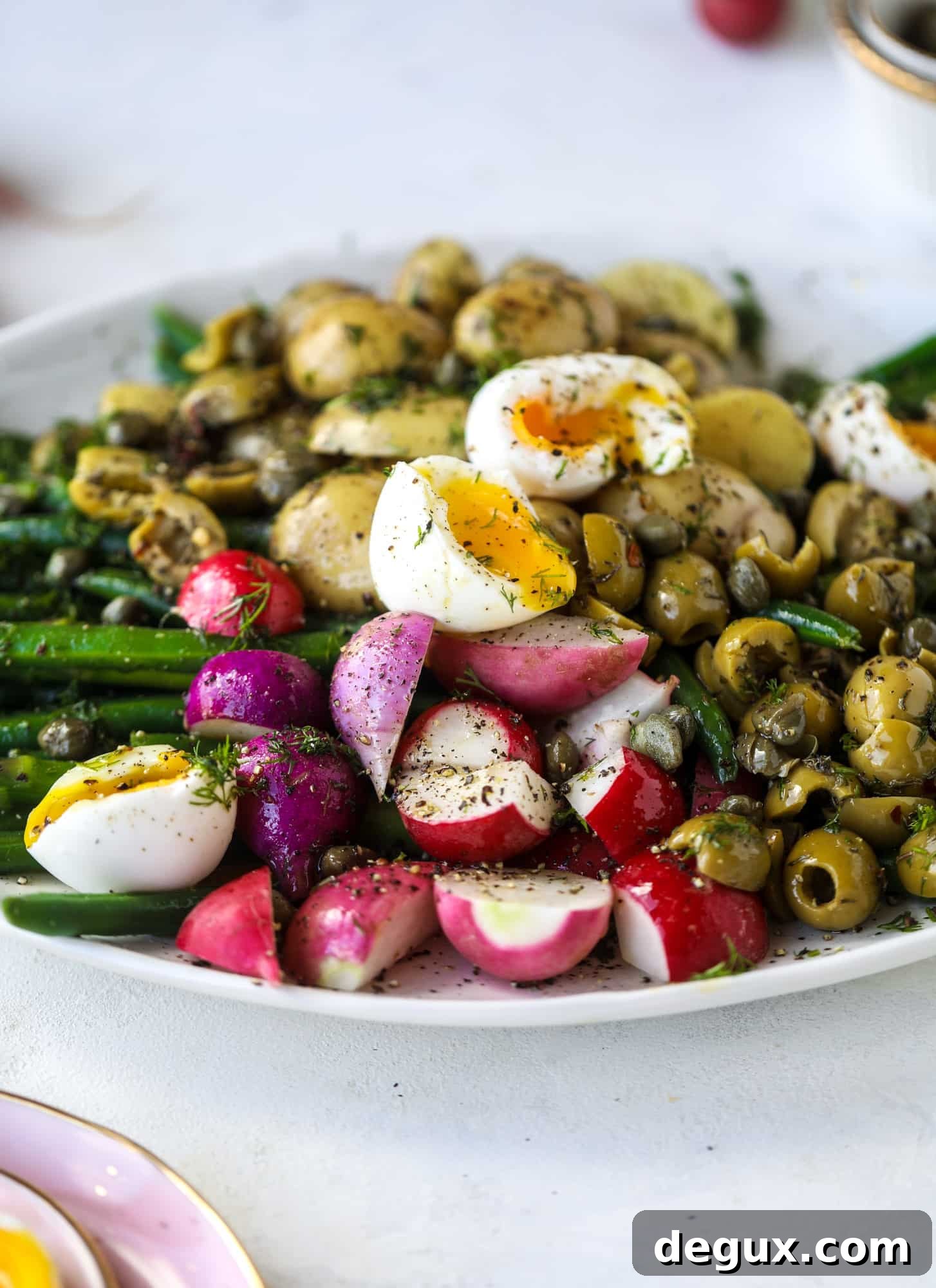 Spring Niçoise Salad Recipe for Fresh Seasonal Ingredients 3 soft boiled eggs on a perfect spring salad