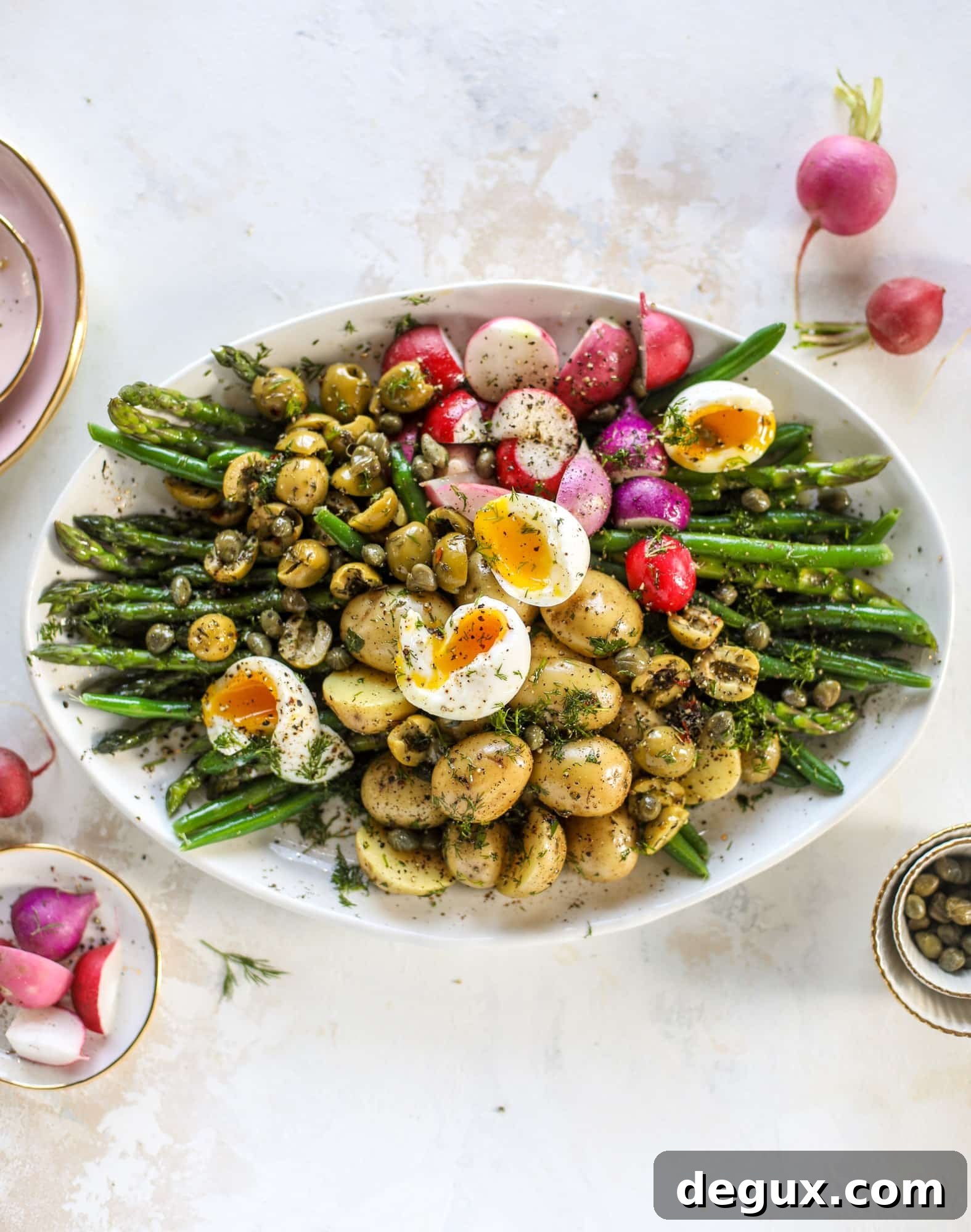 Spring Niçoise Salad Recipe for Fresh Seasonal Ingredients 5 This spring version of the nicoise salad is loaded with crunchy green beans and asparagus, gorgeous radishes, tender potatoes and salty olives.