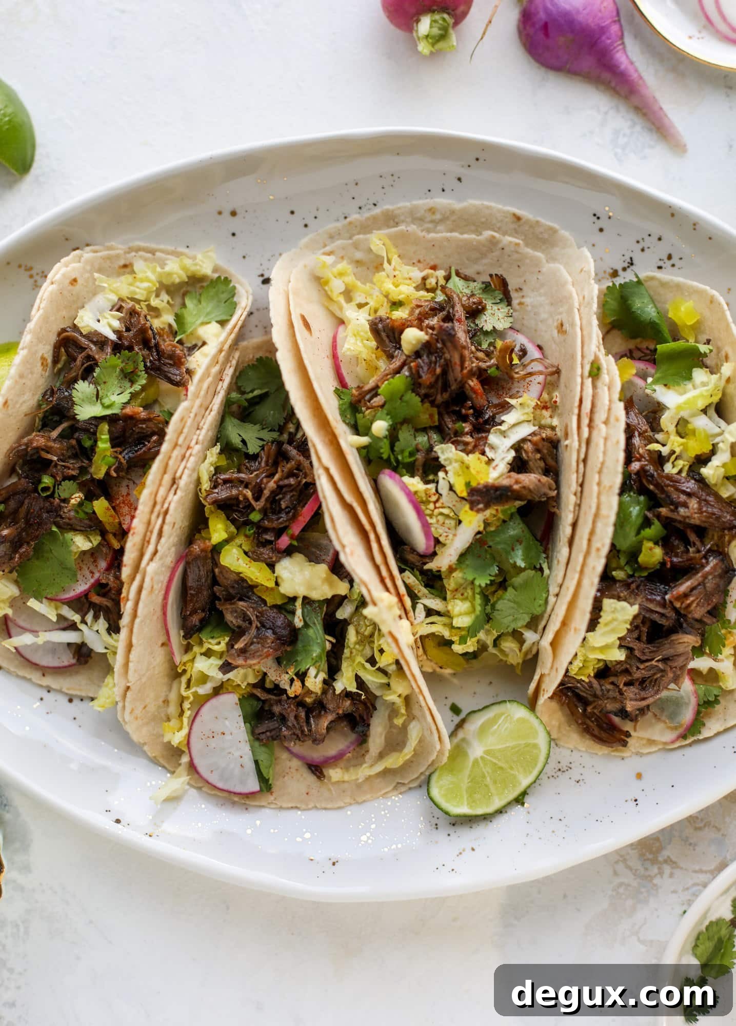 These are the best smoky short rib tacos made in the slow cooker! Served with a banana pepper mustard and napa cabbage slaw, it's a flavor explosion.