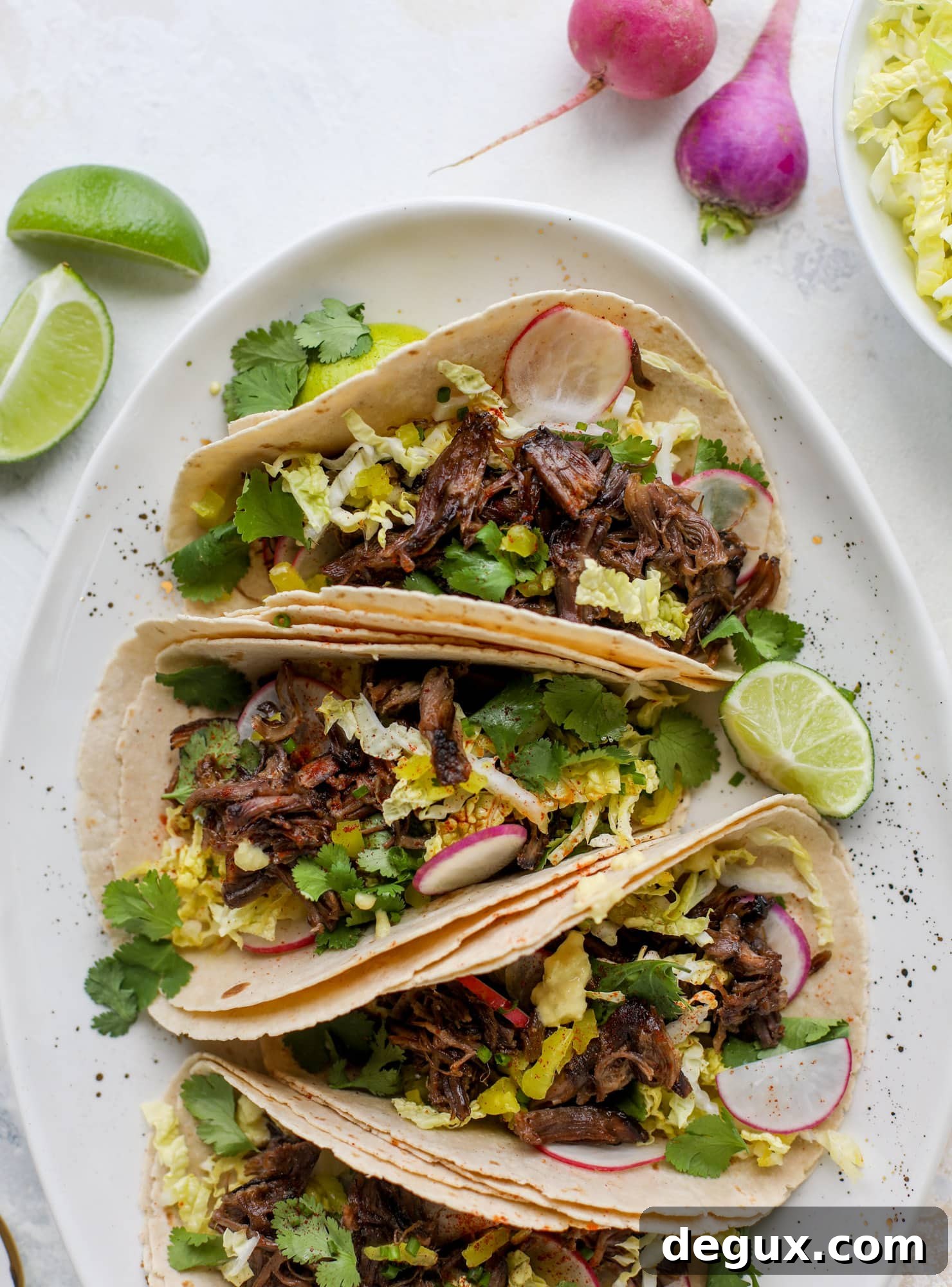 These are the best smoky short rib tacos made in the slow cooker! Served with a banana pepper mustard and napa cabbage slaw, it's a flavor explosion.