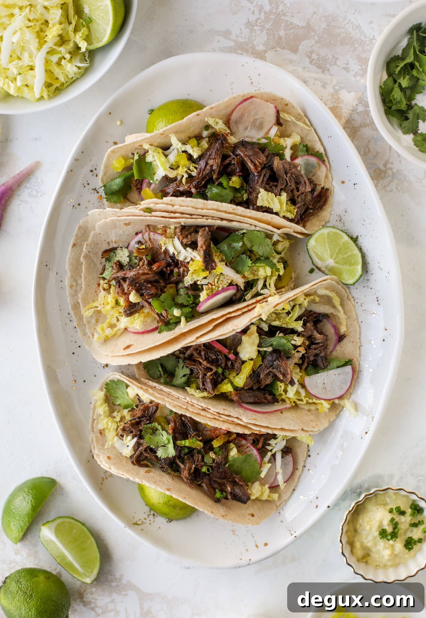 These are the best smoky short rib tacos made in the slow cooker! Served with a banana pepper mustard and napa cabbage slaw, it's a flavor explosion.