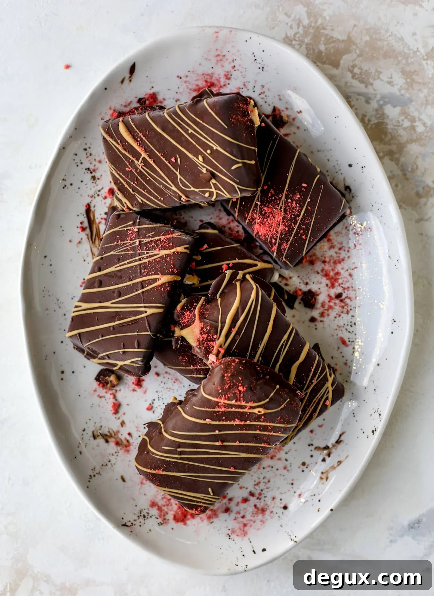 These frozen peanut butter jelly bars are super easy and made with an oatmilk frozen dessert, then covered in a dark chocolate shell. Delish!